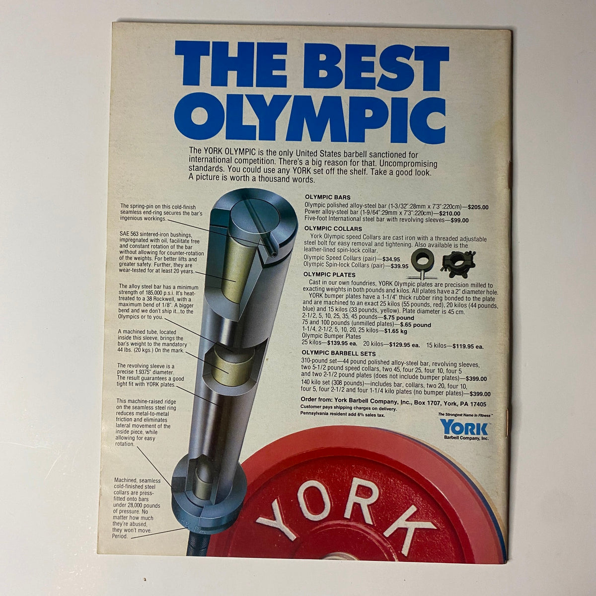 Vintage advertisement for York Olympic weightlifting equipment featuring detailed illustrations of Olympic bars and collars. Highlighted text reads 'THE BEST OLYMPIC,' showcasing the brand's commitment to quality and precision in fitness gear. This design complements the May 1988 issue of Muscular Development Magazine featuring Vince Comerford on the cover.