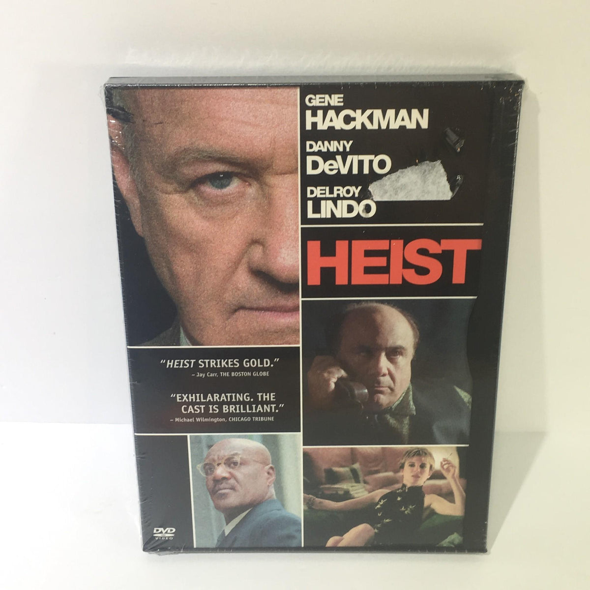 Heist DVD featuring Gene Hackman, Danny DeVito, and Delroy Lindo, showcasing the movie cover with a prominent title.