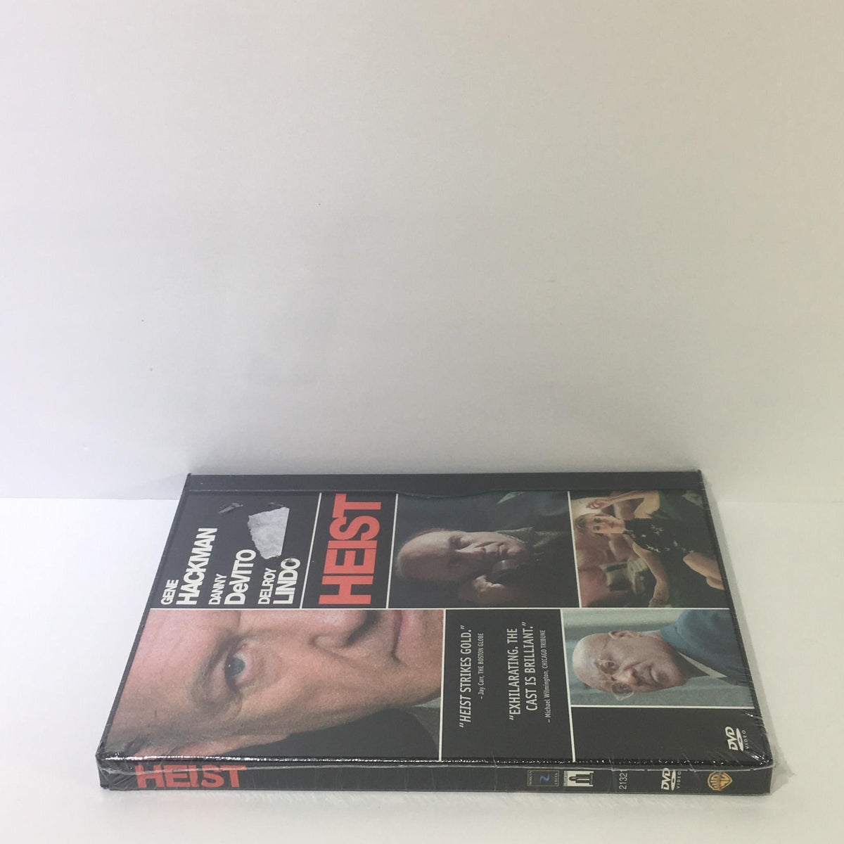 Side view of the Heist DVD featuring the title and images of the cast including Gene Hackman, Danny DeVito, and Delroy Lindo.