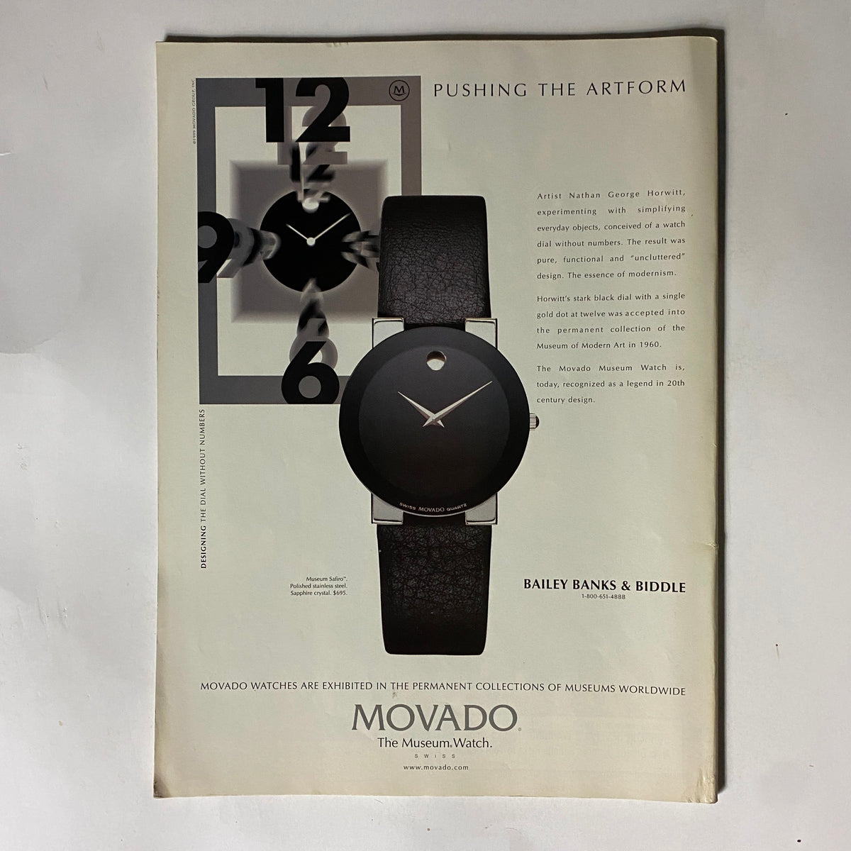 Movado Museum Watch advertisement showcasing a minimalist design with a unique black dial without numbers, accompanied by the title 'Pushing the Artform'. The ad reflects the innovative approach of artist Nathan George Horwitt and includes details about the watch being recognized as a legend in 20th-century design.