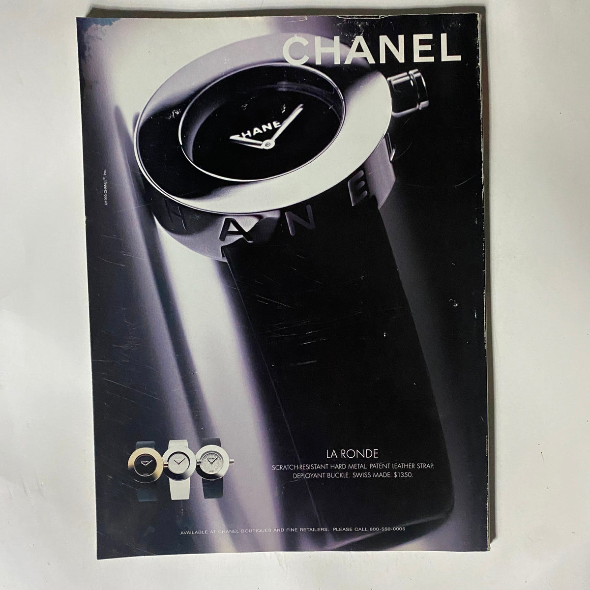Vintage Chanel advertisement featuring a sleek La Ronde watch design with a glossy black finish, shown alongside other timepieces. Ideal for collectors, this image symbolizes luxury fashion and classic style, linking to the George Magazine November 1999 featuring Arnold Schwarzenegger.
