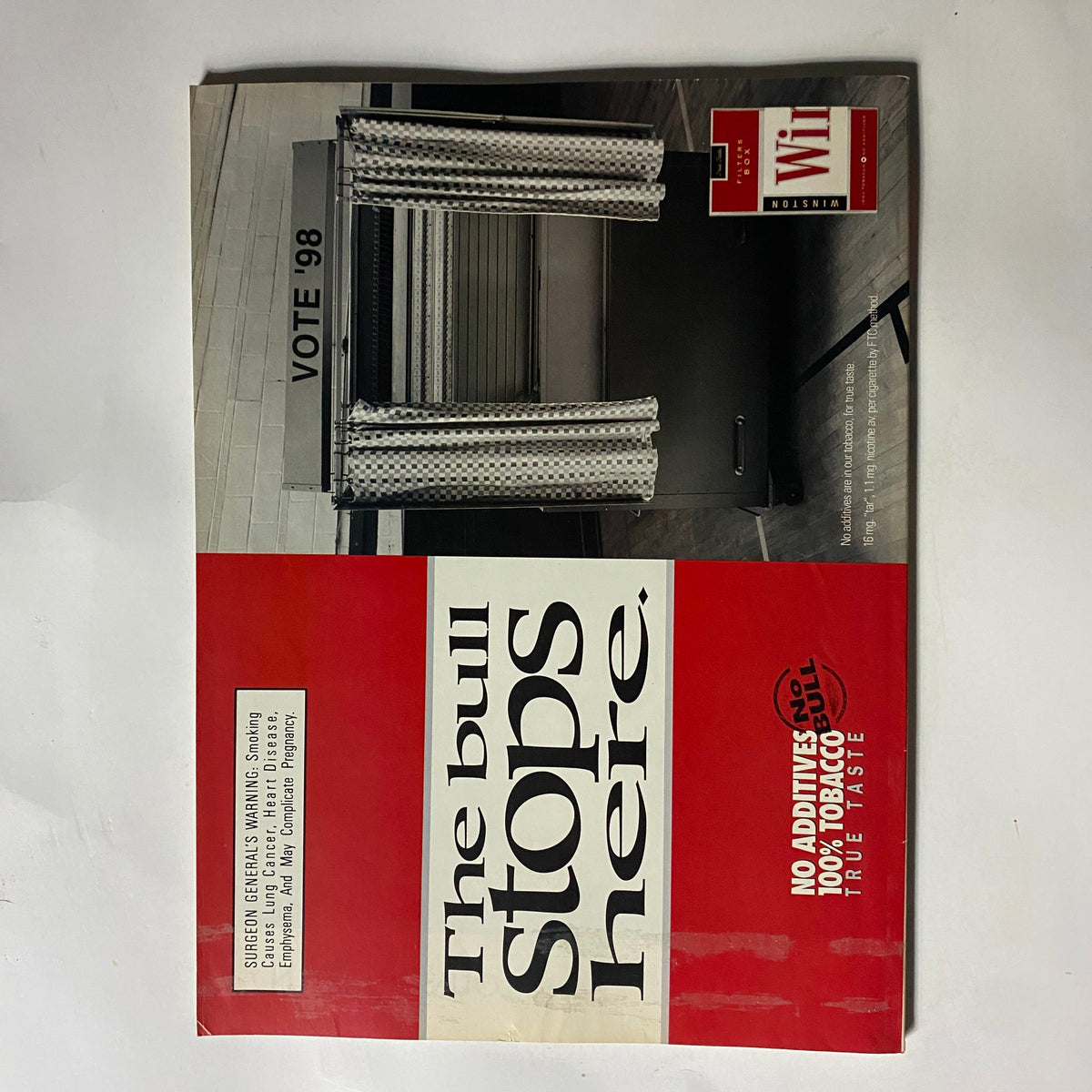 Cover of George Magazine October 1998 titled 'The bull stops here,' showcasing a voting booth with curtains, reflecting political themes of the time.