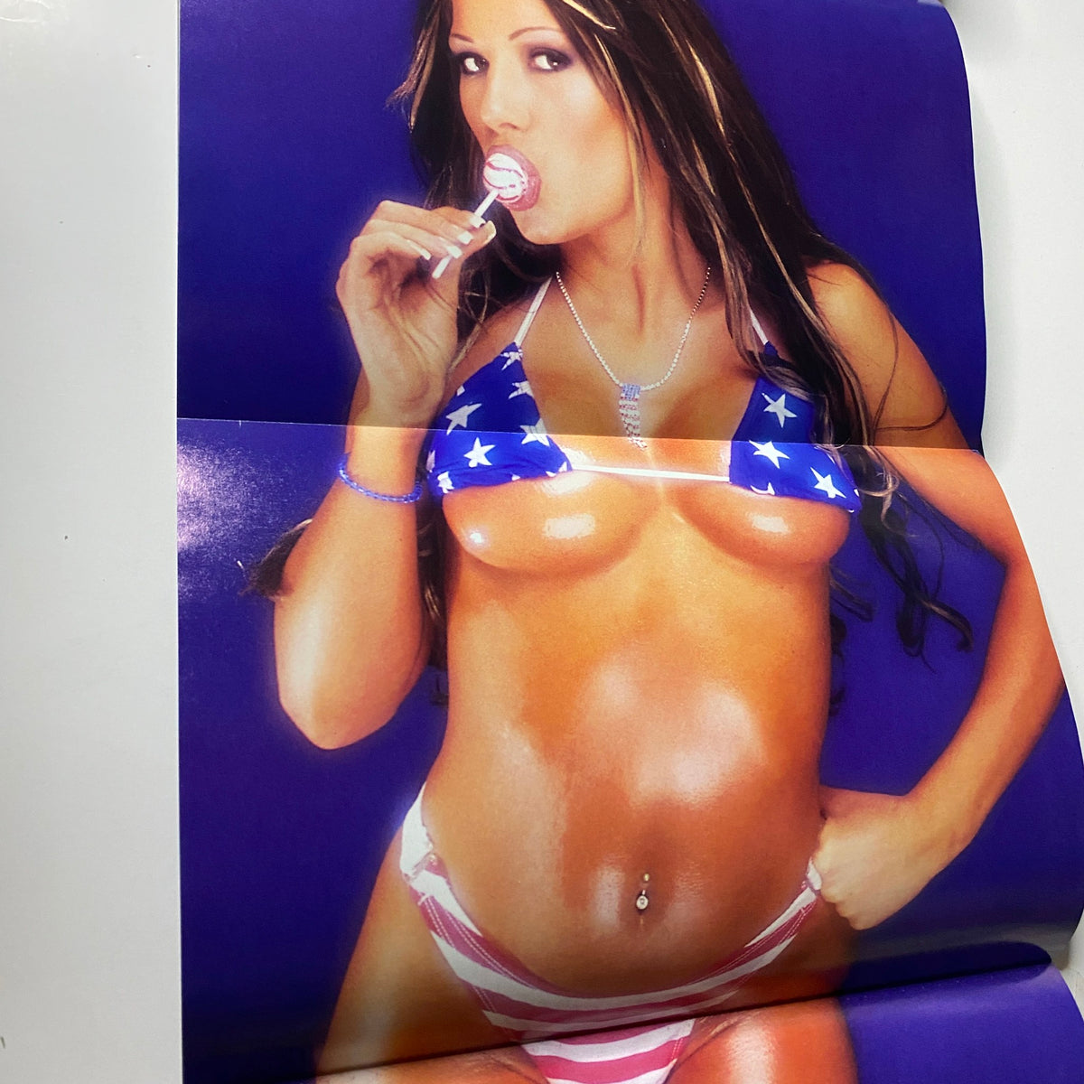 Pull-out poster from Muscular Development Magazine April 2002 featuring Lisa and Mandi in star-spangled attire, promoting fitness and style.