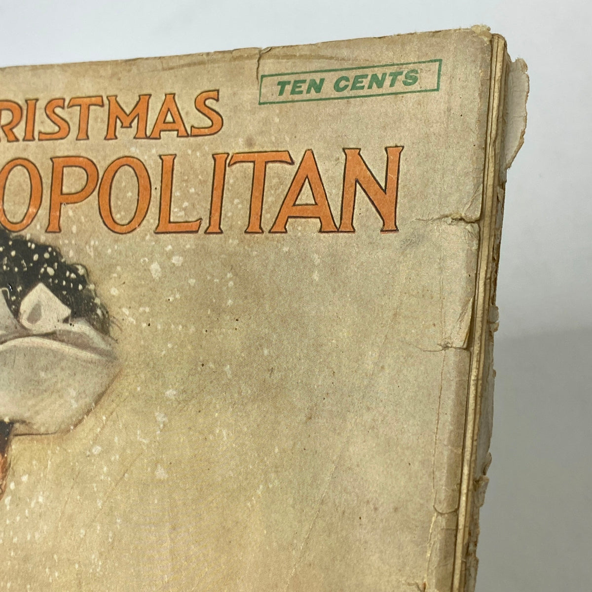 Detail view of the vintage Cosmopolitan Magazine December 1905 cover featuring the title 'Christmas Cosmopolitan' with a vintage illustration and pricing information.