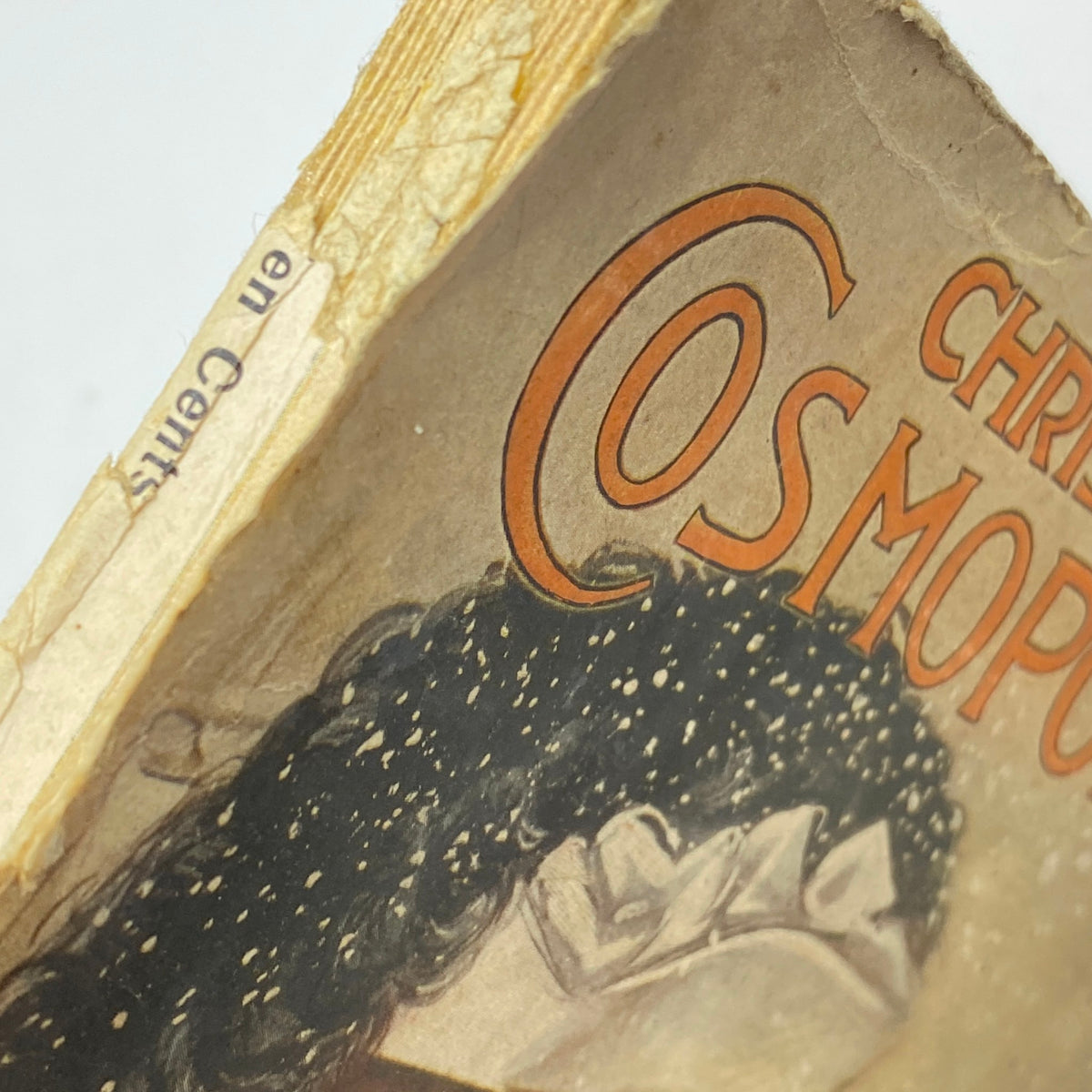 Side view of the vintage Cosmopolitan Magazine December 1905, showcasing the title with decorative elements and a hint of wear, reflecting its historical charm.