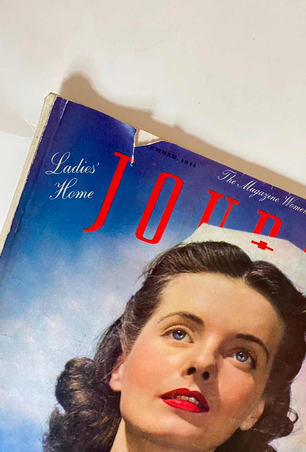Close-up of VTG The Ladies Home Journal September 1941 Diary of Domesticity magazine corner, highlighting the title and a woman's portrait with a nostalgic appeal.