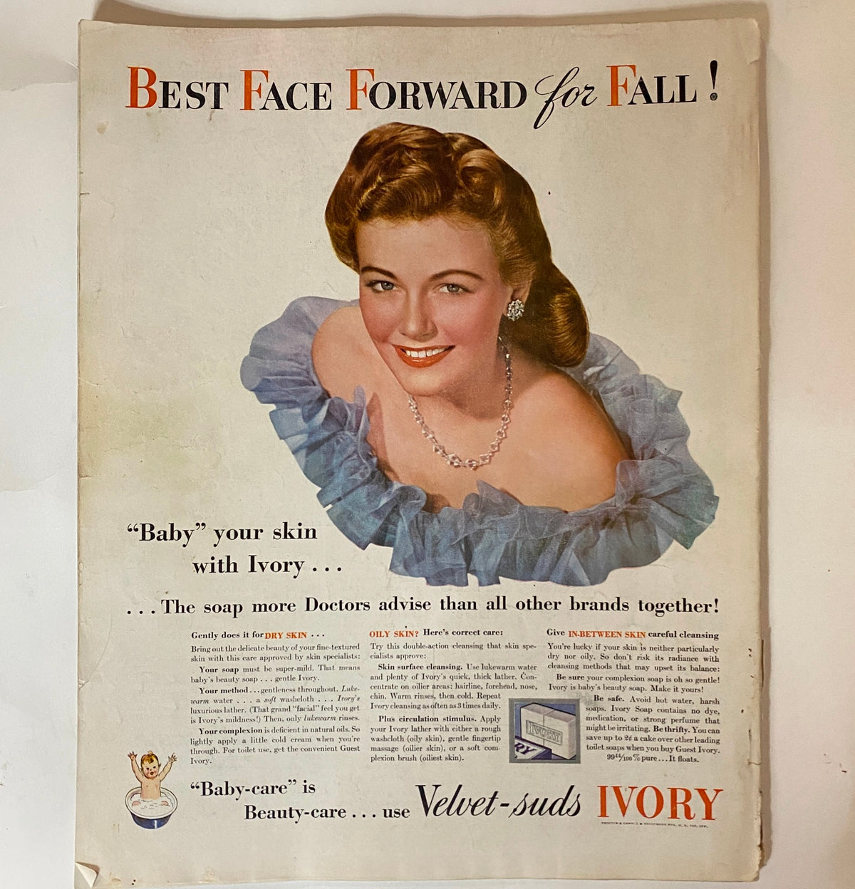Vintage advertisement from Woman's Home Companion Magazine November 1942 promoting Ivory soap, featuring a smiling model adorned in jewelry and soft blue fabric.