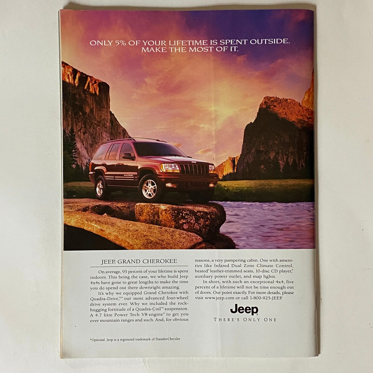 Advertisement page in Tennis Magazine, November 1999, for the Jeep Grand Cherokee, featuring a scenic outdoor landscape with a Jeep vehicle, emphasizing outdoor adventure.