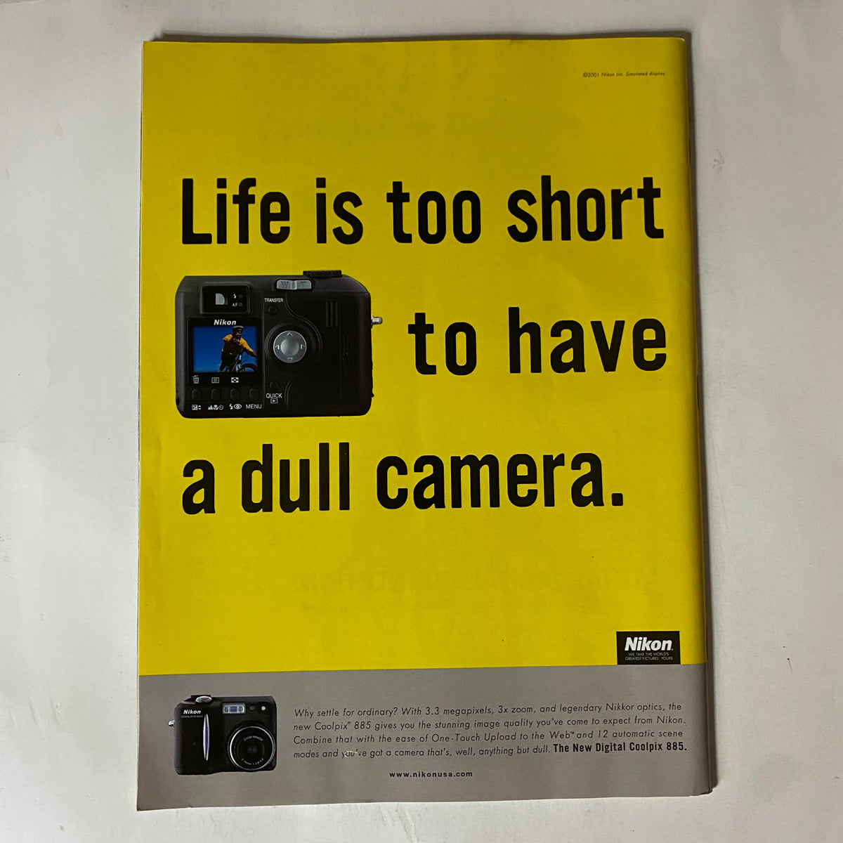 Advertisement in Tennis Magazine November 2001 promoting Nikon cameras with the tagline 'Life is too short to have a dull camera'.