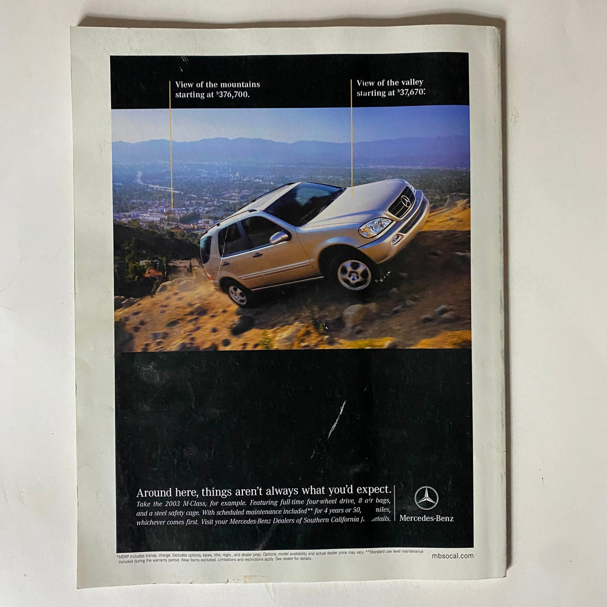 Back cover of Inside Tennis Magazine 2003 Southern California Yearbook displaying a Mercedes-Benz advertisement with a scenic valley view, emphasizing luxury and style in the context of Southern California.