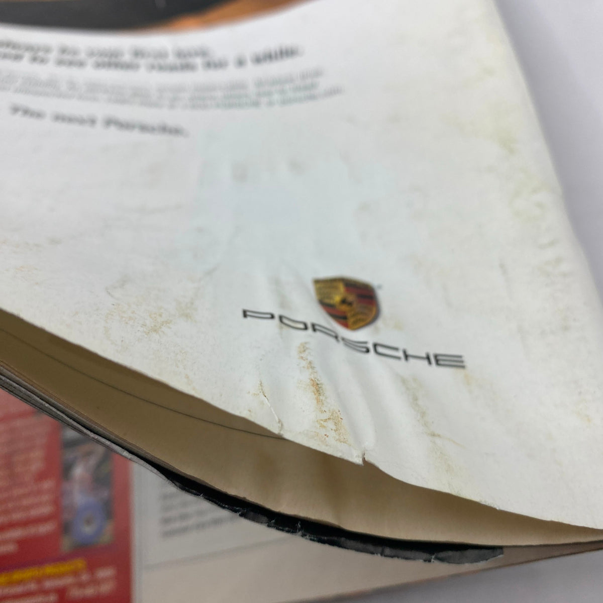 Close-up of the back cover of Tennis Magazine July 2003, showing a Porsche logo and minor wear on the edge, reflecting its vintage nature.
