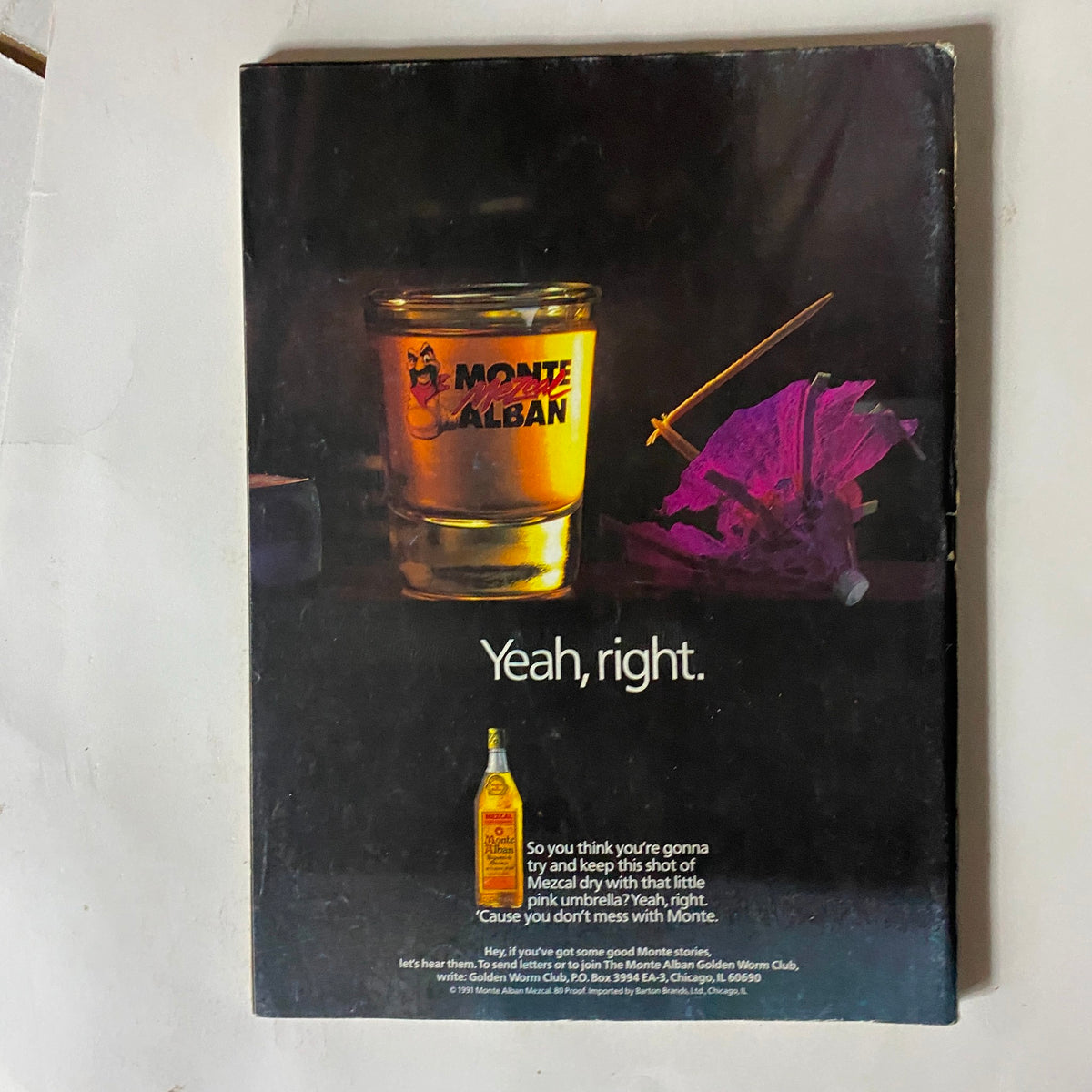Back cover of VTG Easyriders Magazine June 1991 featuring a humorous advertisement for Monte Alban Mezcal, showcasing a shot glass with the brand logo, a decorative umbrella, and the text 'Yeah, right.' This collectible magazine highlights 20 years of motorcycle culture.