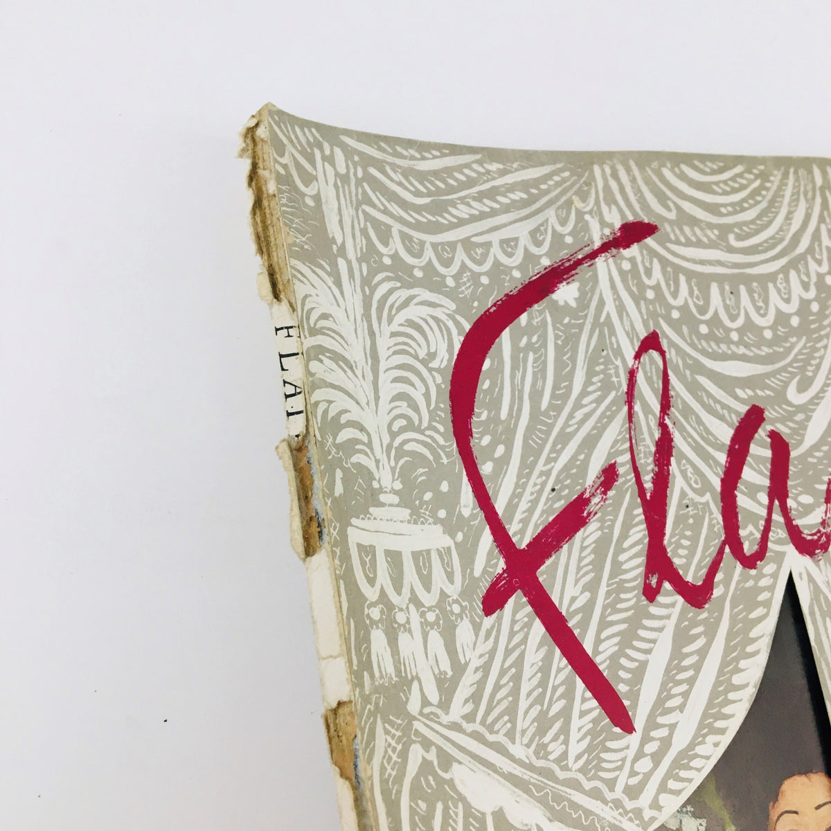 Side view of VTG Flair Magazine October 1950 Vol. 1 No. 9 showing the worn edges and classic design elements of the cover.