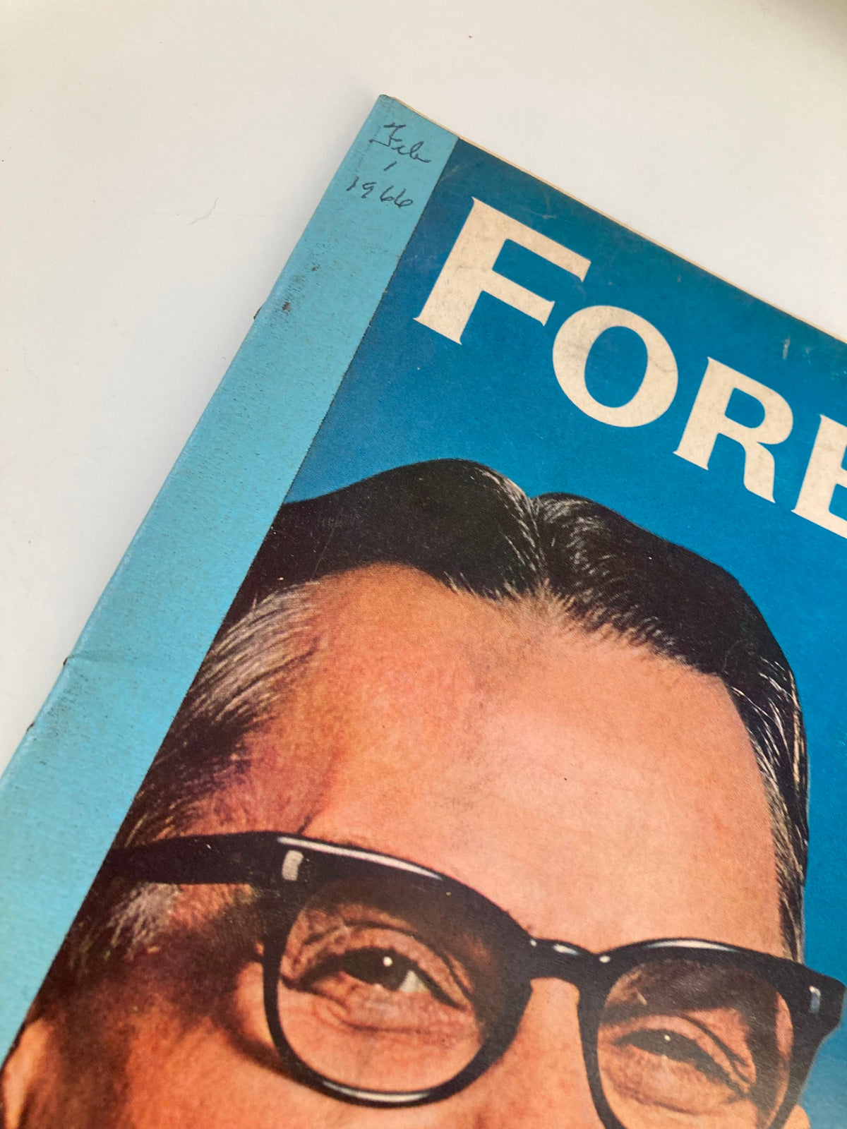 Detailed view of the corner of the VTG Forbes Magazine February 1 1966 cover with a handwritten date and partial cover design.