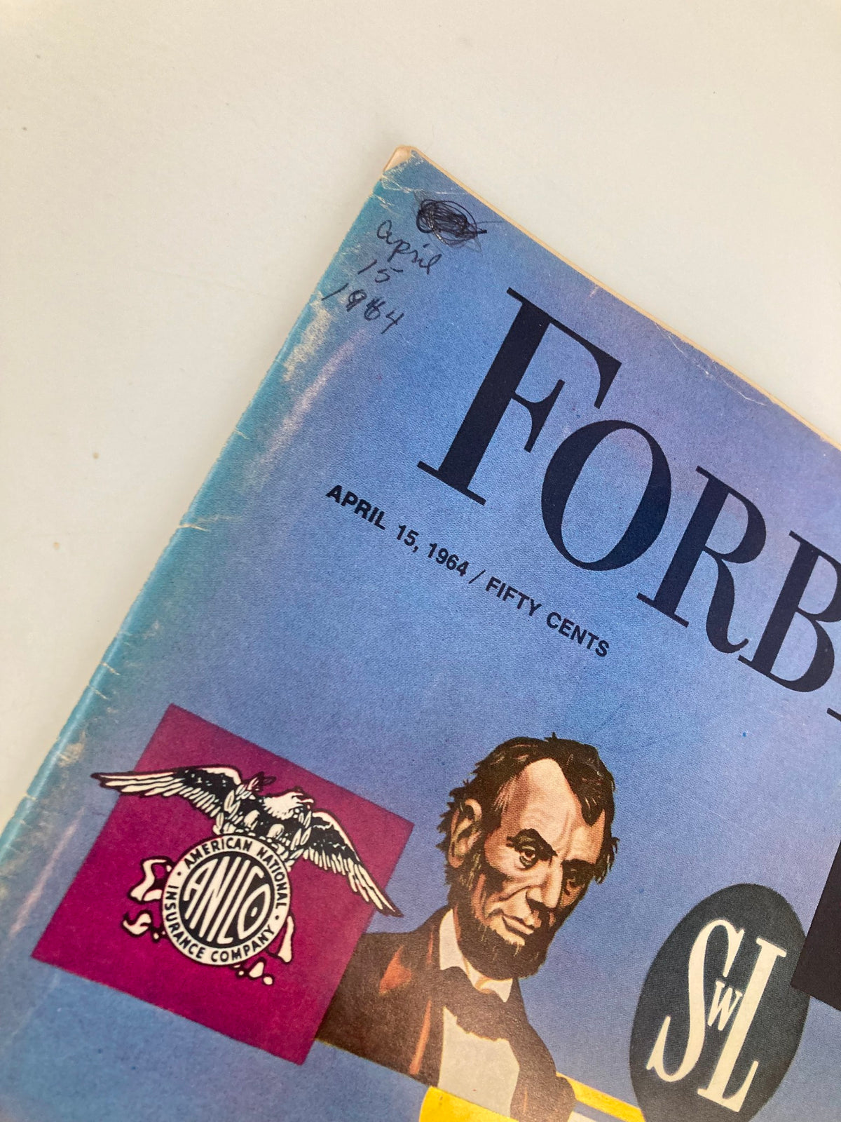 Close-up of the cover of VTG Forbes Magazine April 15 1964, featuring a blue background, the magazine title, and artwork including a portrait of Abraham Lincoln and American National Insurance Company logo.