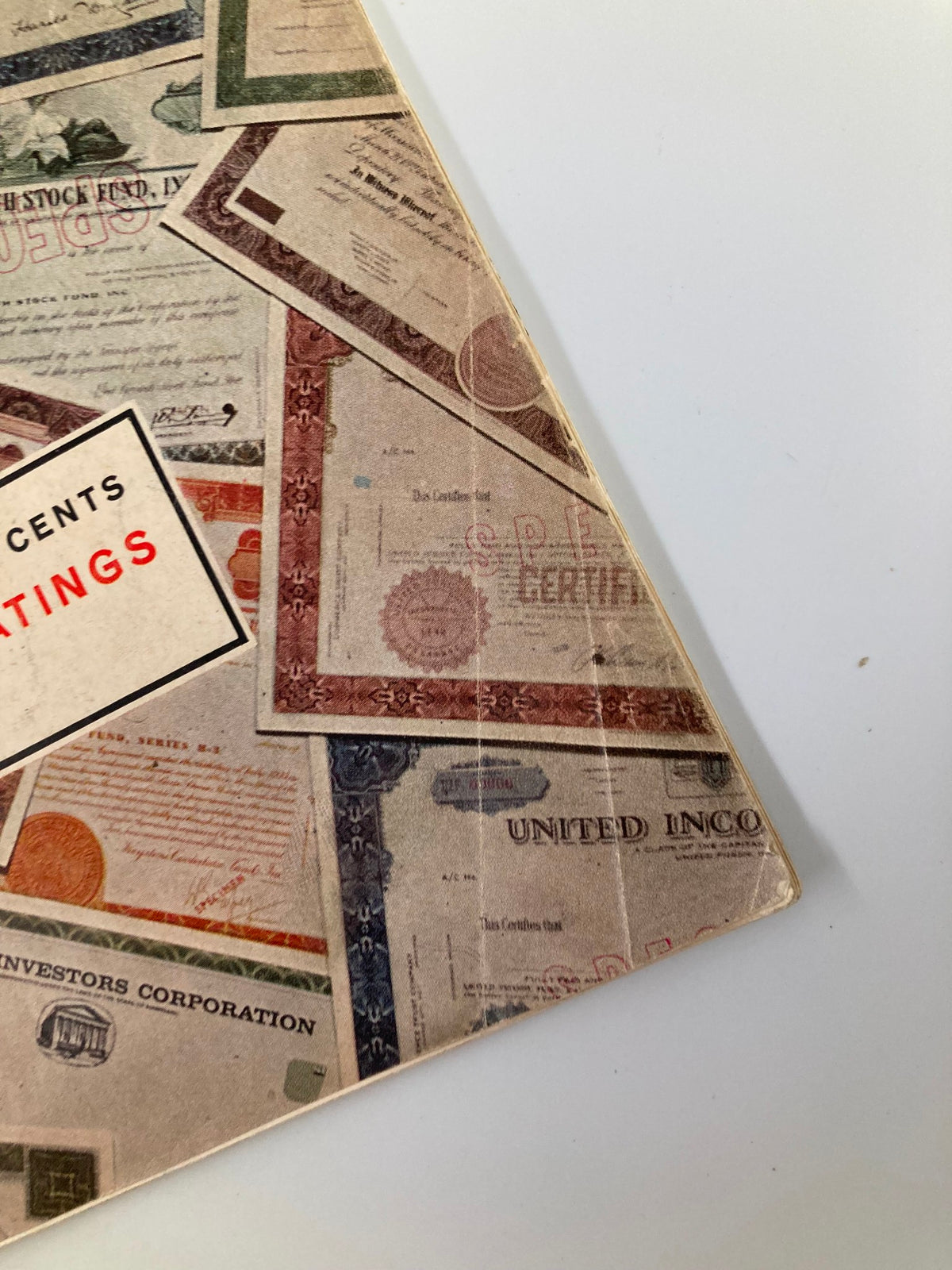 Close-up view of the corner of the VTG Forbes Magazine August 15 1965 showing details of stock certificates on the cover.