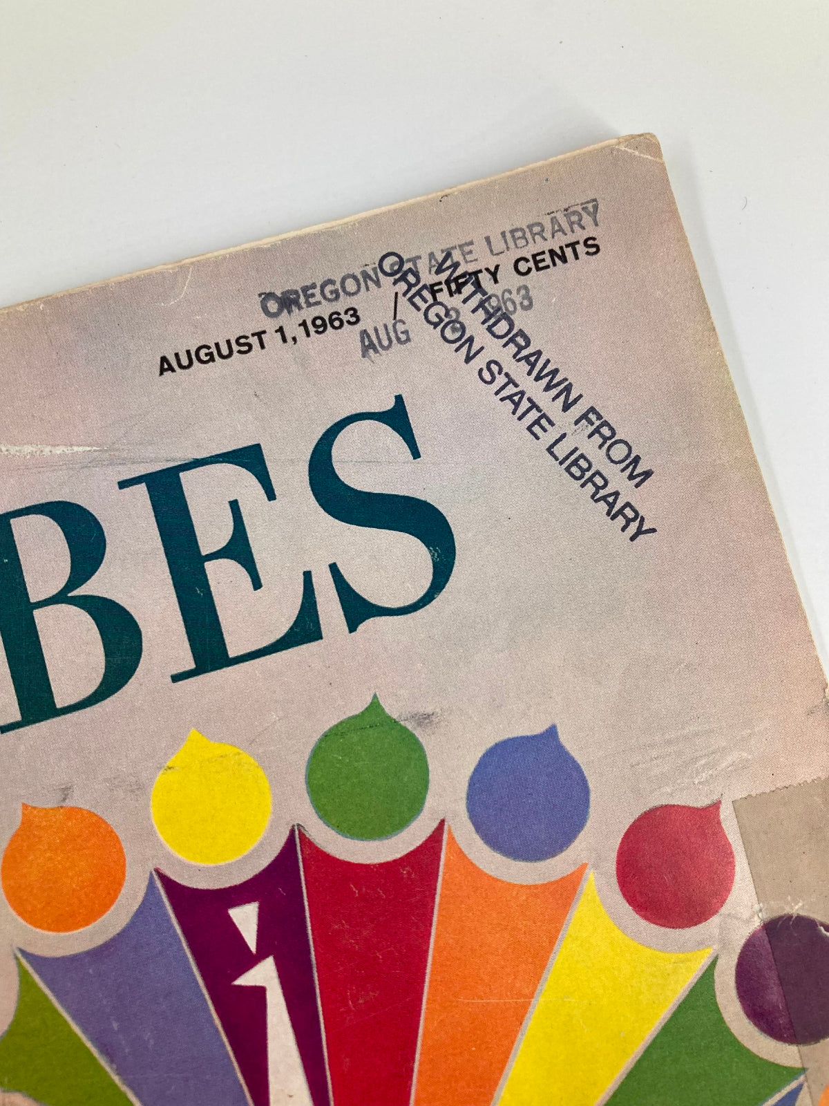 Detail of the VTG Forbes Magazine October 1 1963 cover with a stamp indicating it was withdrawn from the Oregon State Library.