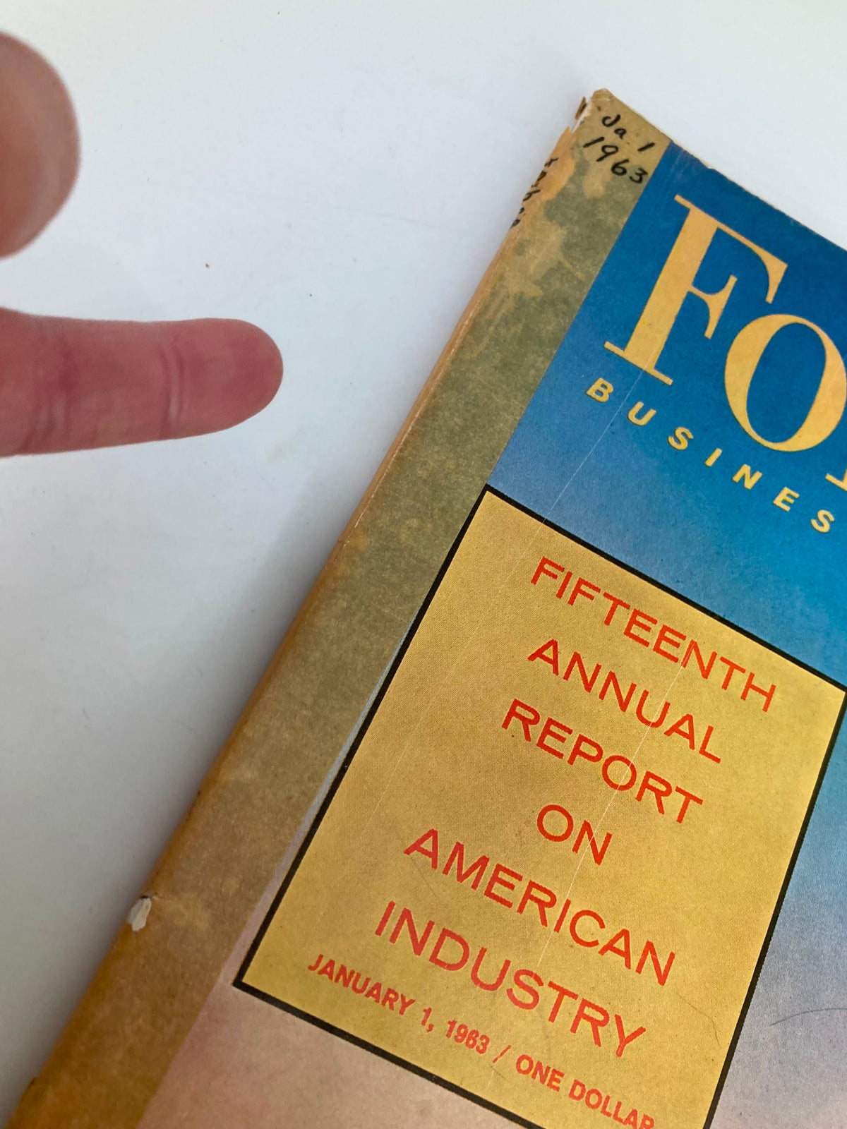 Close-up view of the right side of VTG Forbes Magazine January 1, 1963, with handwritten date and magazine title prominently displayed.