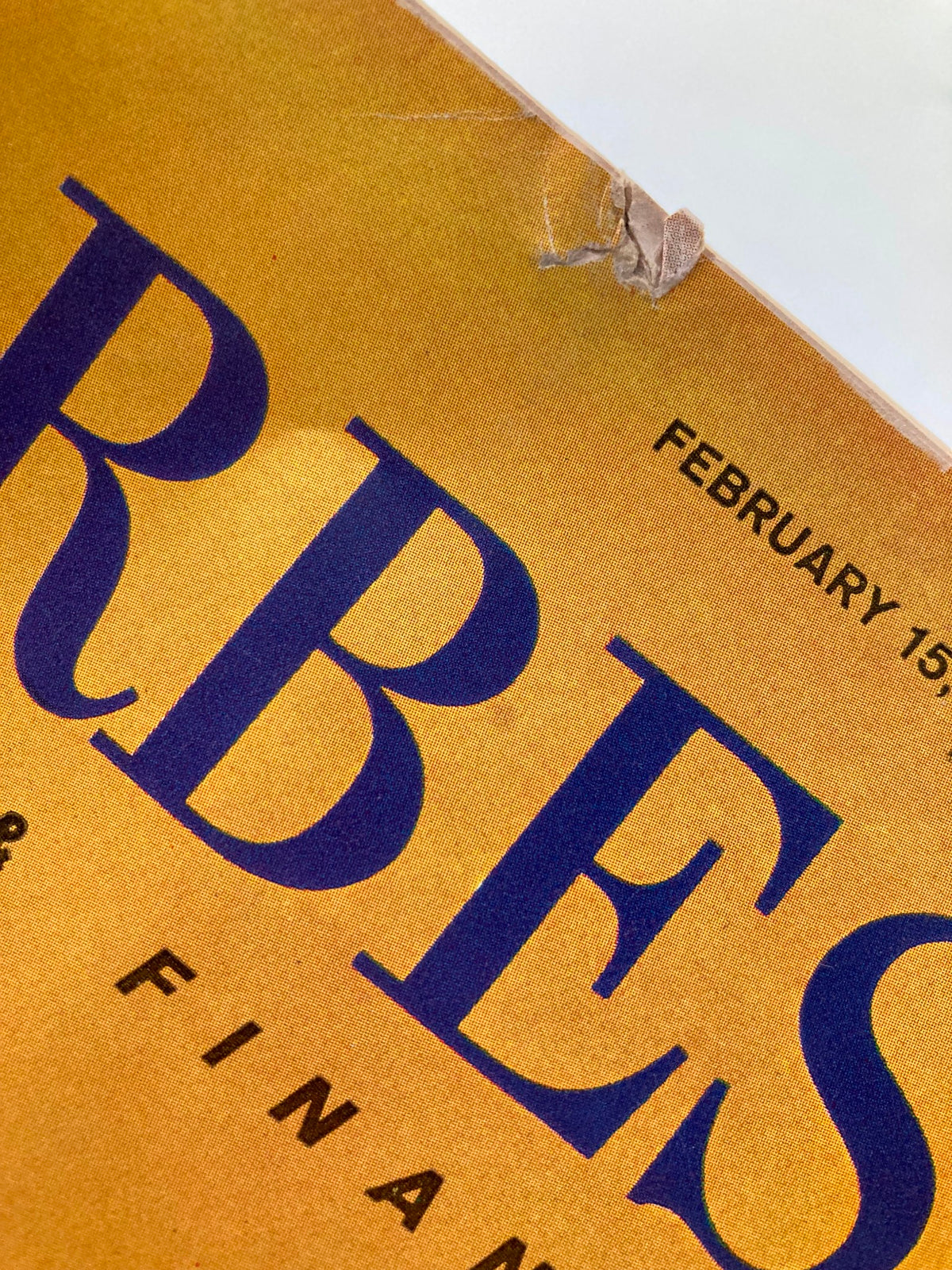 Close-up of the cover of VTG Forbes Magazine, February 15, 1963, displaying the title and date, along with some wear imperfections indicative of its vintage age.
