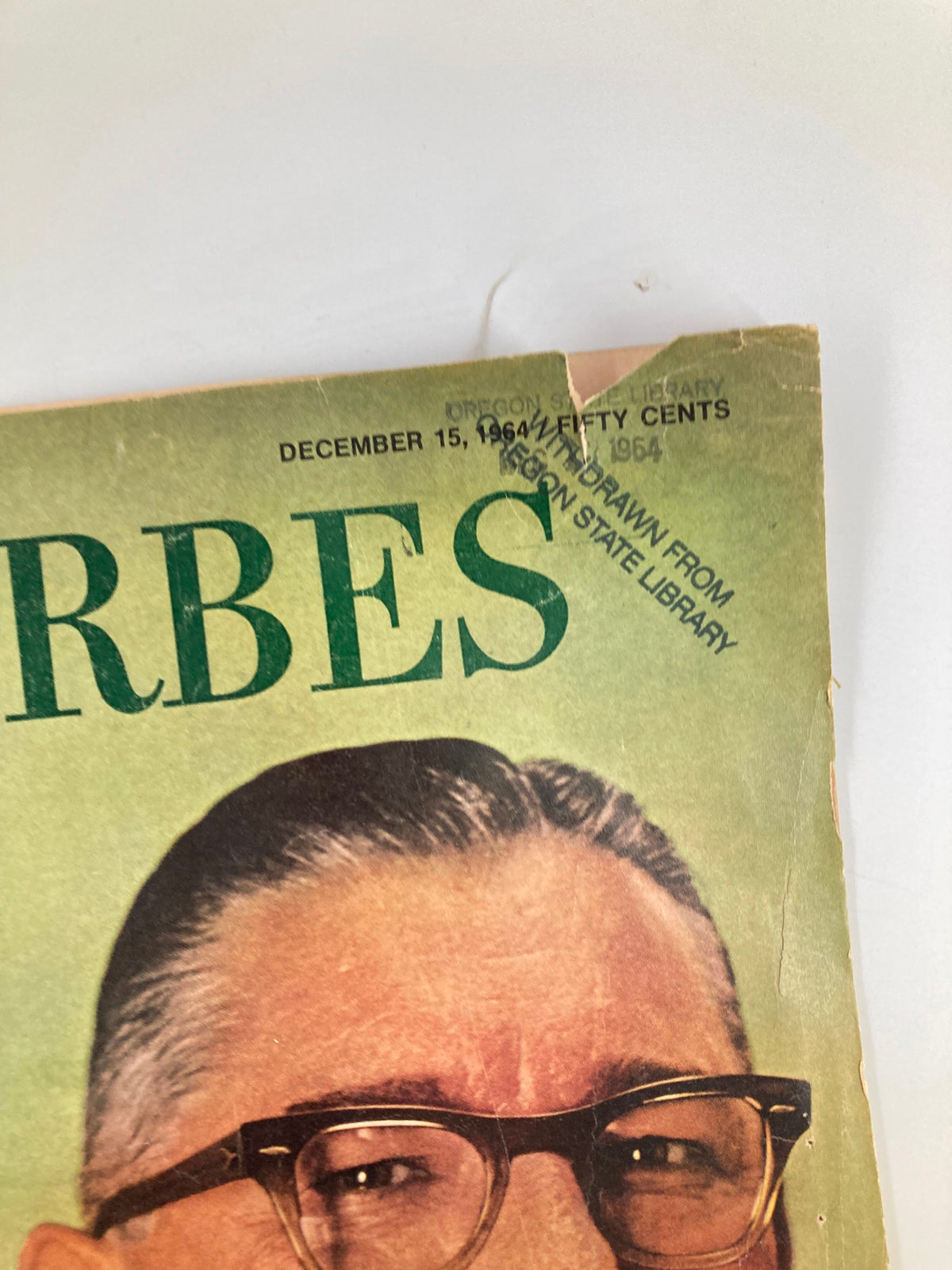 Close-up of the date and details on the cover of VTG Forbes Magazine December 15 1964 with a library stamp.