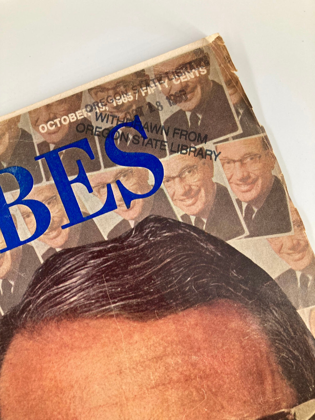 Detailed view of the vintage Forbes magazine cover with a stamp from the Oregon State Library and the date October 15, 1965.