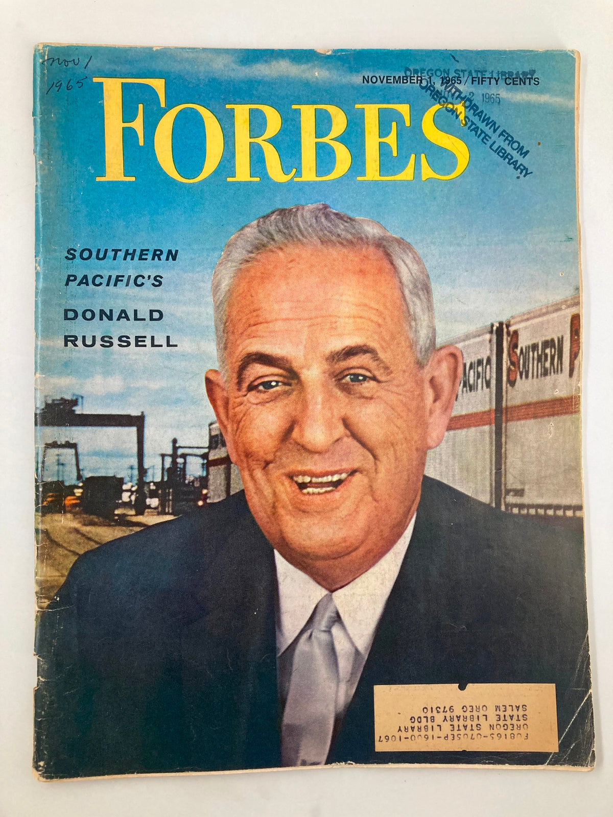 Cover of VTG Forbes Magazine dated November 1, 1965, featuring Southern Pacific's Donald Russell with an image of him smiling against a backdrop of railroad operations. Perfect for vintage magazine collectors.