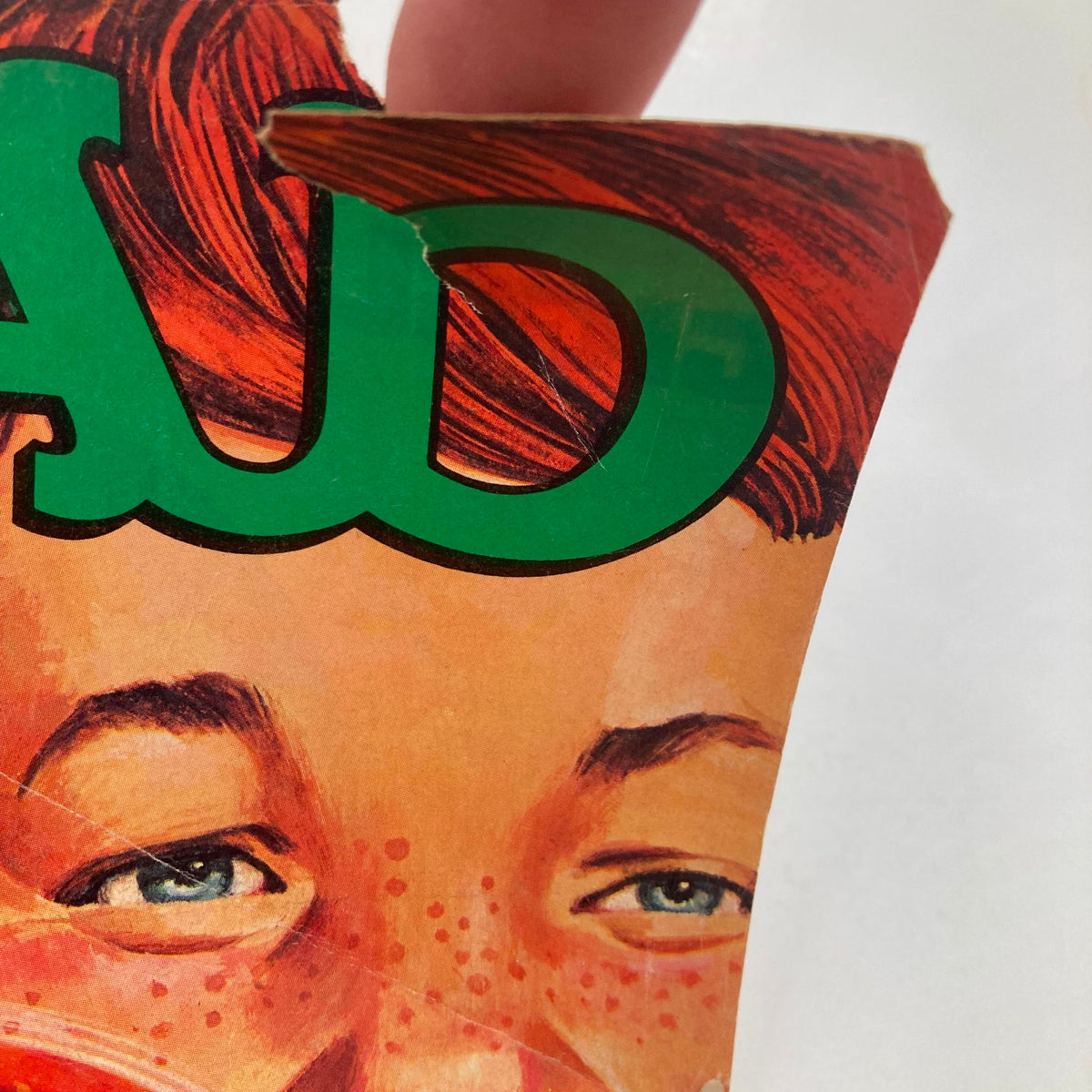 Close-up detail of the Mad Magazine June 1980 No. 215 cover showing the iconic bold green 'MAD' logo and expressive eyes of the character.