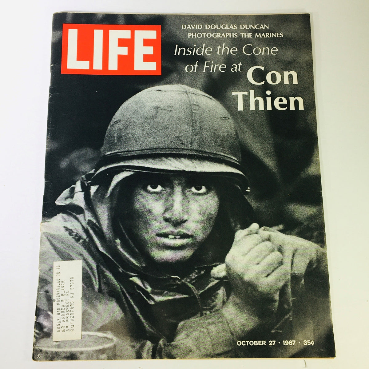 Cover of VTG Life Magazine from October 27, 1967, featuring a striking black and white photograph by David Douglas Duncan of a U.S. Marine. The cover highlights the theme 'Inside the Cone of Fire at Con Thien' showing the resilience and spirit of Marines during the Vietnam War.