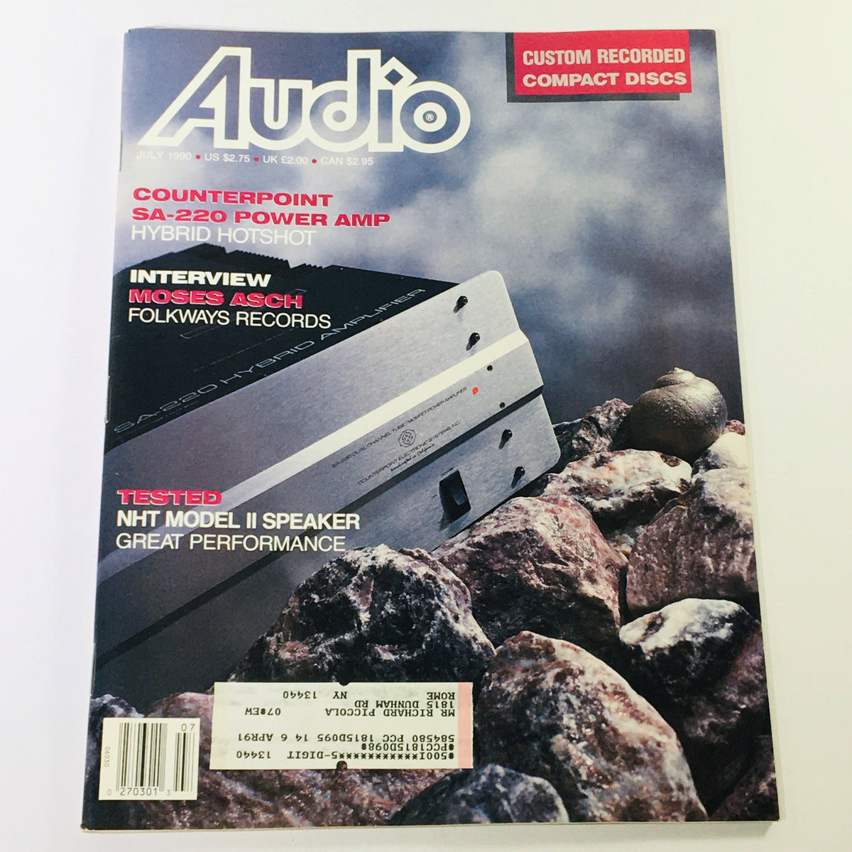 Cover of Audio Magazine July 1990 featuring an interview with Moses Asch and a review of the NHT Model II Speaker, showcasing audio technology advancements.