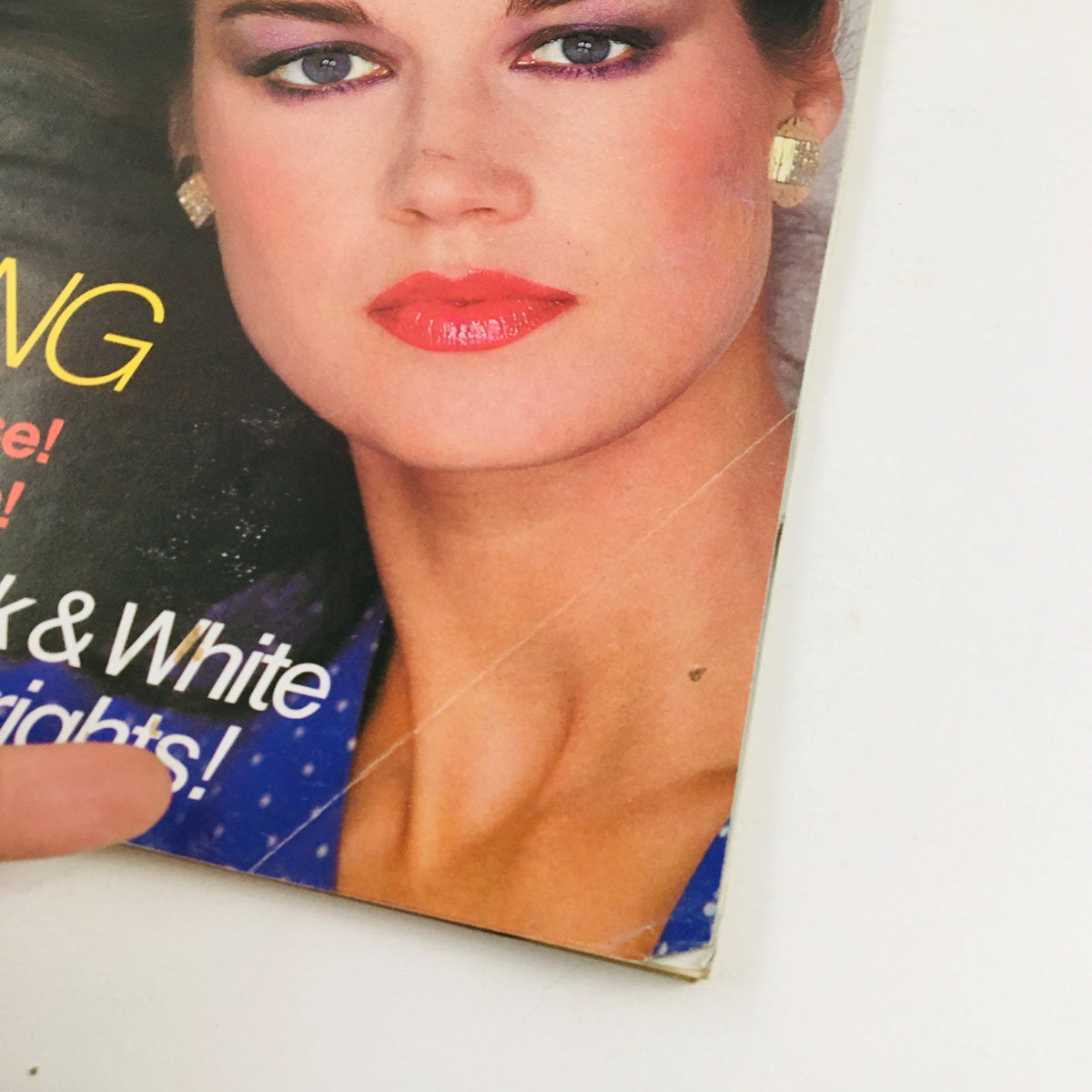 Close-up of the Vogue Patterns Magazine March 1980 cover, showcasing the model's radiant face, colorful makeup, and stylish earrings, embodying the vibrant fashion of the 80s.