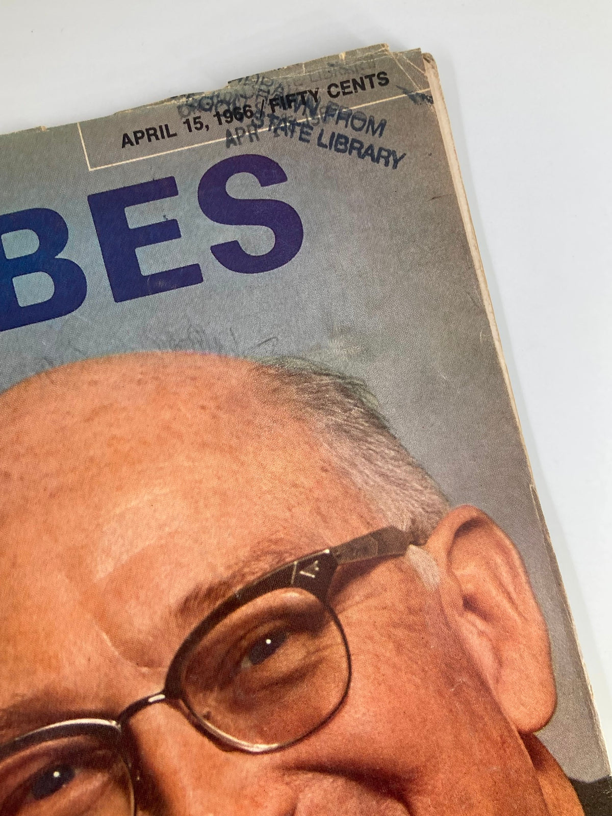Close-up view of the VTG Forbes Magazine from April 15, 1966, showcasing the magazine title and a library stamp indicating its past use. This collectible features John L. Burns of Cities Service.