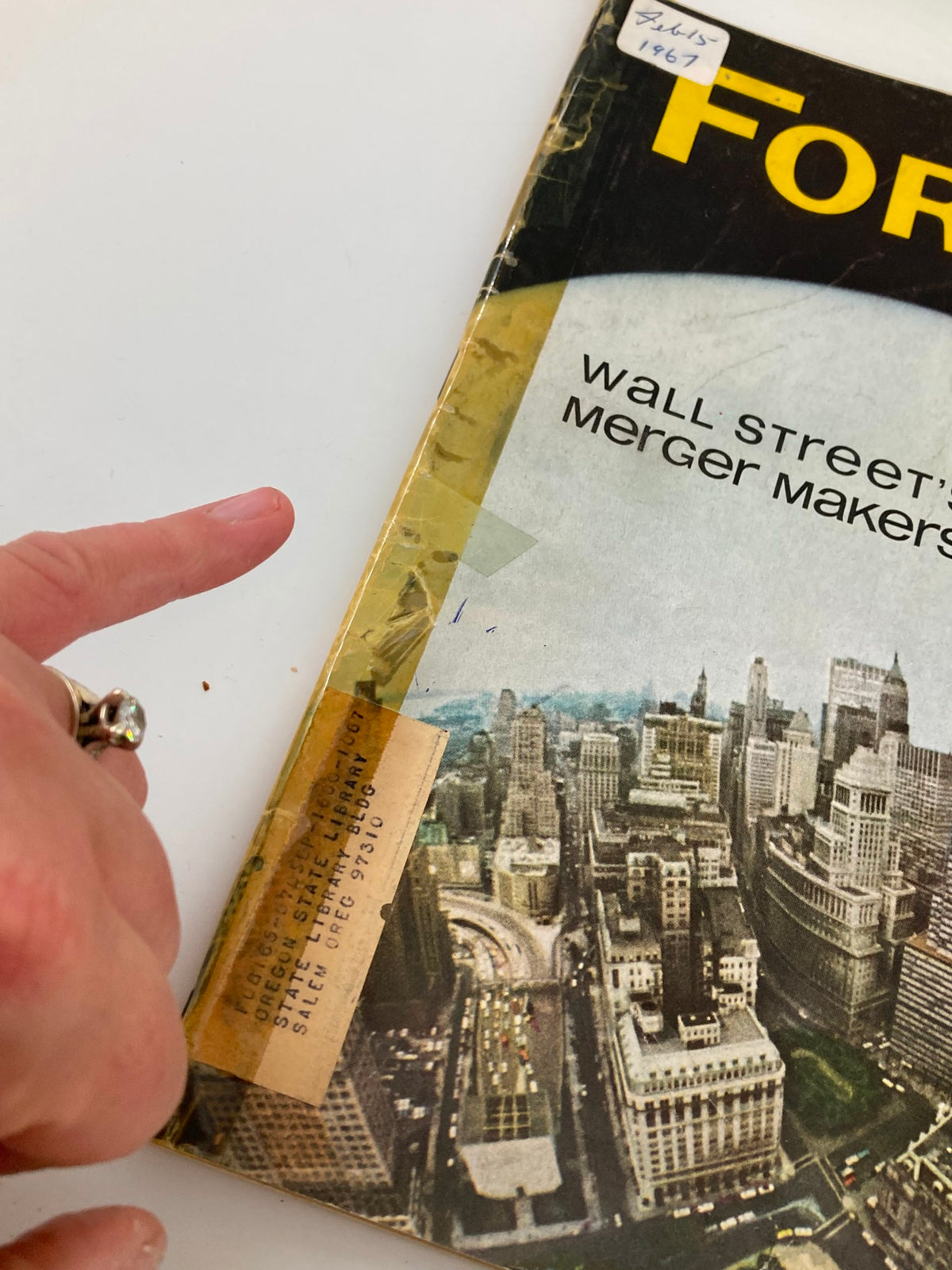 Close-up of the cover of Forbes Magazine, February 15, 1967, highlighting the title 'Wall Street's Merger Makers' and library label.