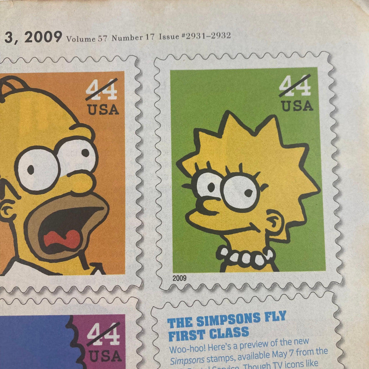 Close-up of a section from TV Guide Magazine April 20 2009 featuring cartoon stamps of Homer and Lisa Simpson with the title 'The Simpsons Fly First Class'.