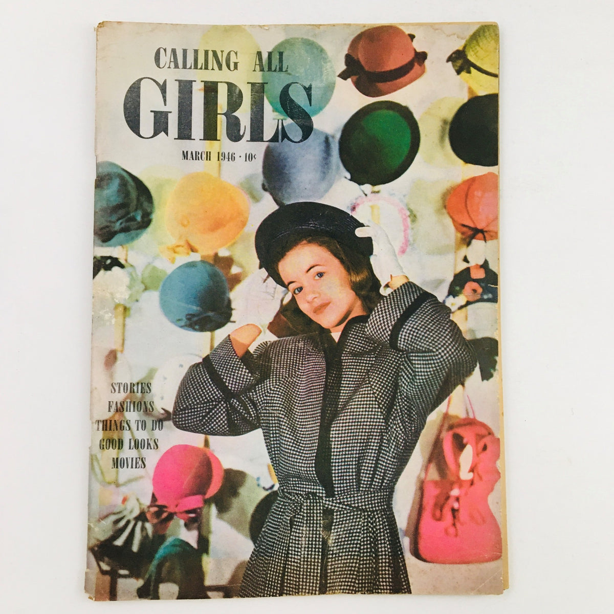 Cover of Calling All Girls Magazine March 1946 featuring a young woman in a stylish coat and hat surrounded by colorful hats, showcasing the theme of fashion and women's empowerment.