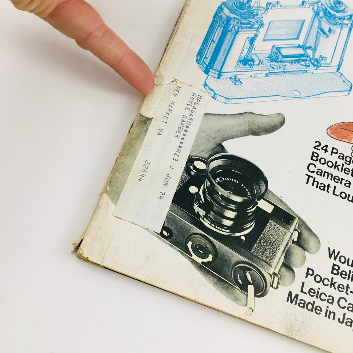 Detail of the cover of Modern Photography Magazine, October 1973, showcasing a camera and an address label, emphasizing vintage photography themes.