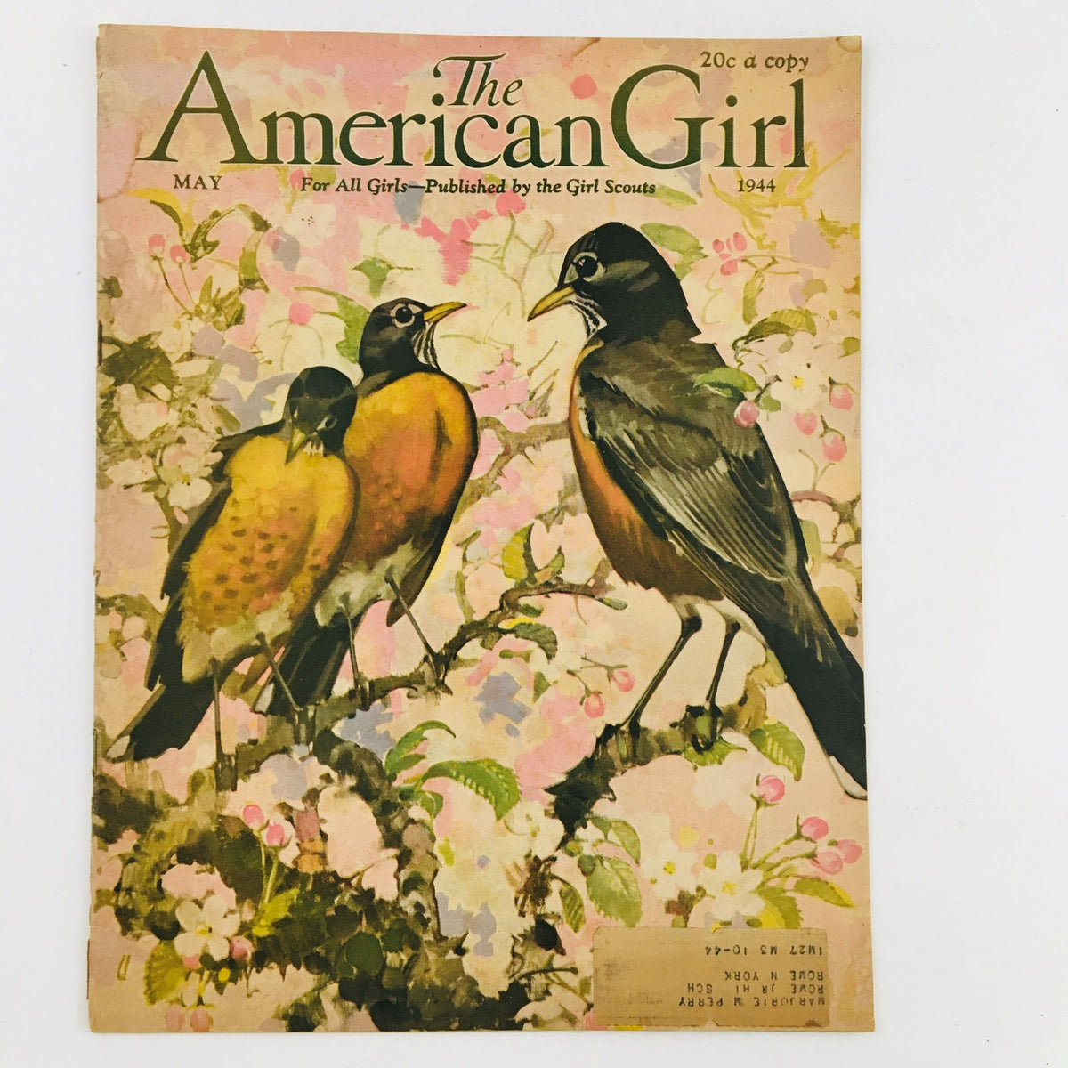 Front cover of The American Girl Magazine, May 1944 edition, featuring the painting 'Whistling Boy' by Frank Duveneck, showcasing two birds perched on a branch surrounded by floral elements.
