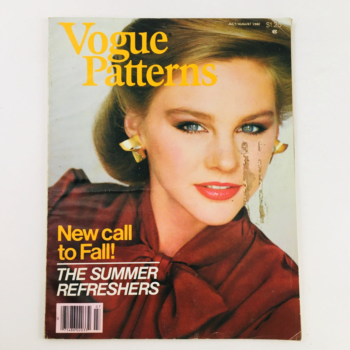 Vogue Patterns Magazine July 1980 cover featuring a model with bold makeup and yellow accessories, showcasing summer fashion inspirations.