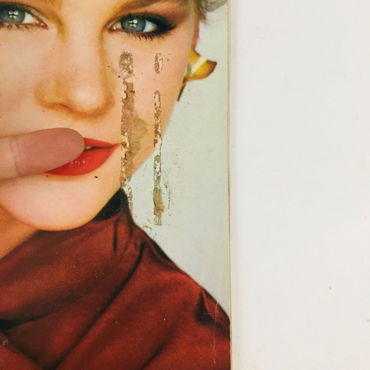 Close-up of the cover of Vogue Patterns Magazine July 1980 highlighting a model's face with red lipstick and a stylish red blouse.