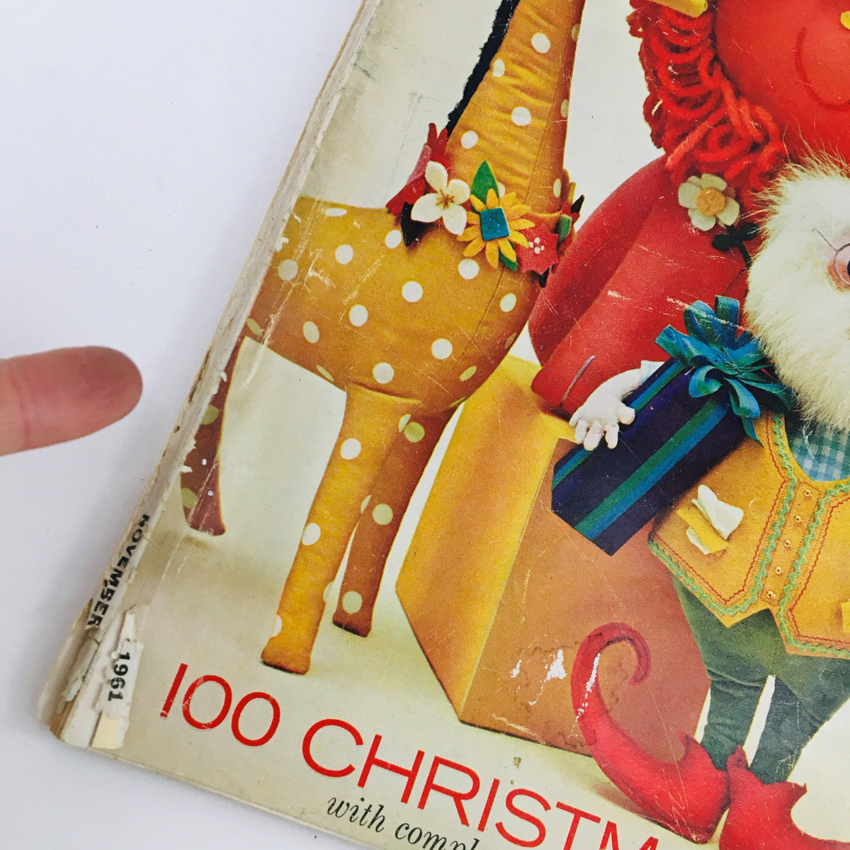 Close-up of the spine of Woman's Day Magazine November 1961, showcasing the publication date and title, emphasizing its vintage collectible nature.