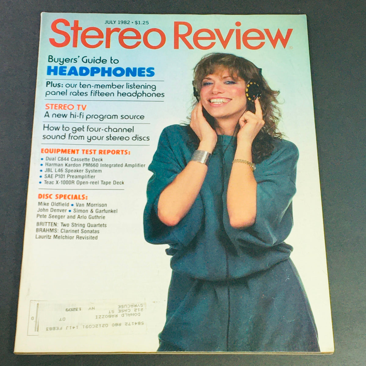 Vintage July 1982 Stereo Review Magazine cover featuring a smiling woman wearing headphones, with the title 'Stereo Review' prominently displayed. Highlights include a buyers' guide to headphones, equipment test reports, and music features on Mike Oldfield, Van Morrison, and John Denver.