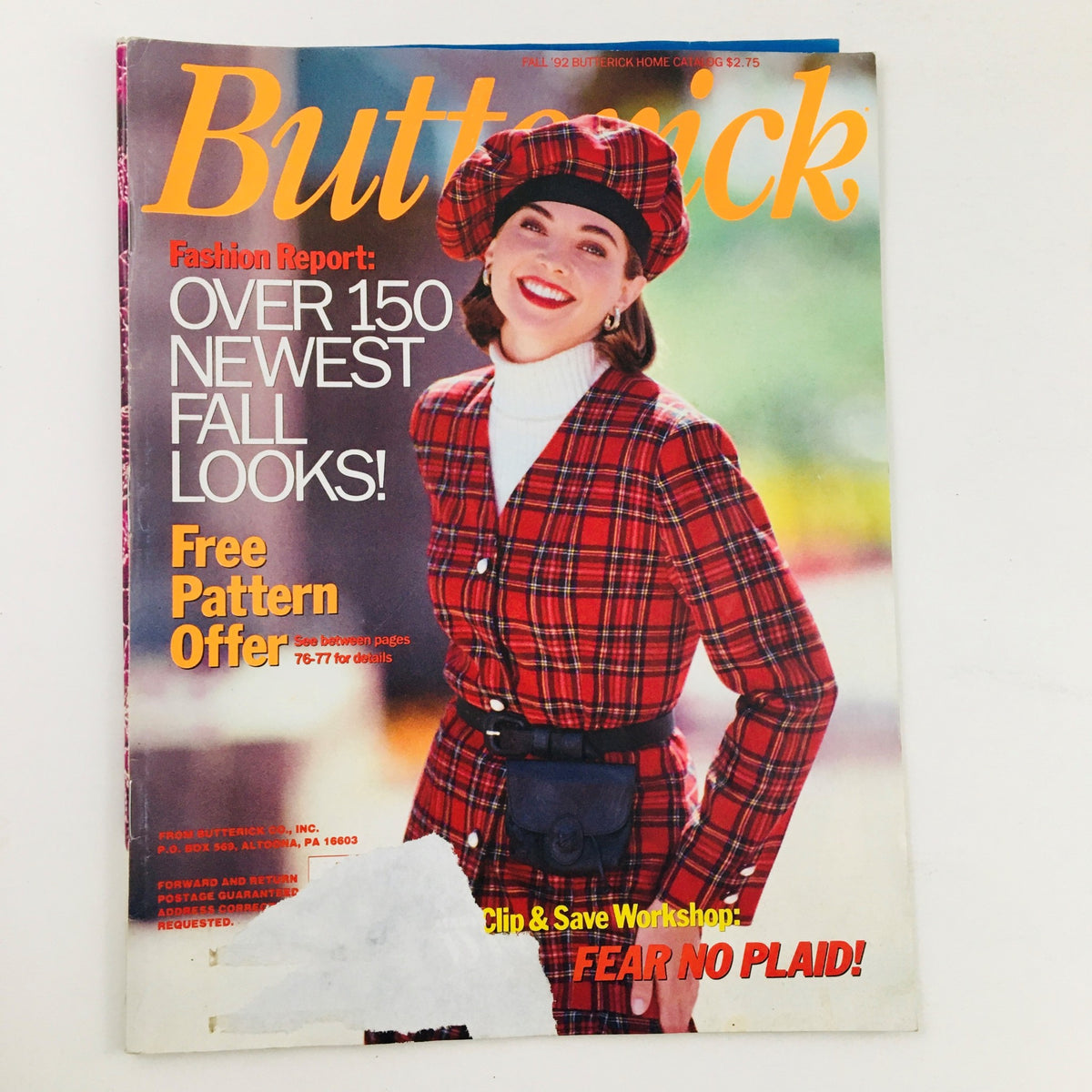 Cover of Butterick Magazine Fall 1992 featuring a model in a plaid outfit and hat, promoting the newest fall looks and free pattern offer.