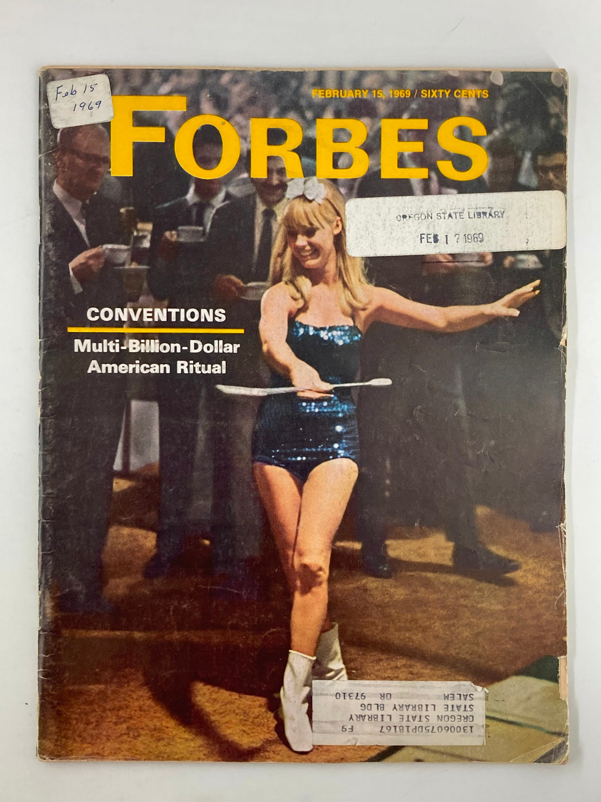 Cover of the vintage Forbes Magazine dated February 15, 1969, highlighting the theme 'Multi-Billion-Dollar American Ritual' with an image of a performer in a sequined outfit.