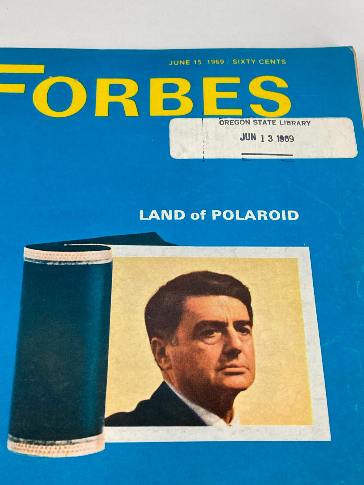 Close-up view of the cover of VTG Forbes Magazine, June 15, 1969, highlighting the 'LAND of POLAROID' section and a man’s portrait alongside the vibrant blue background and yellow 'FORBES' title.