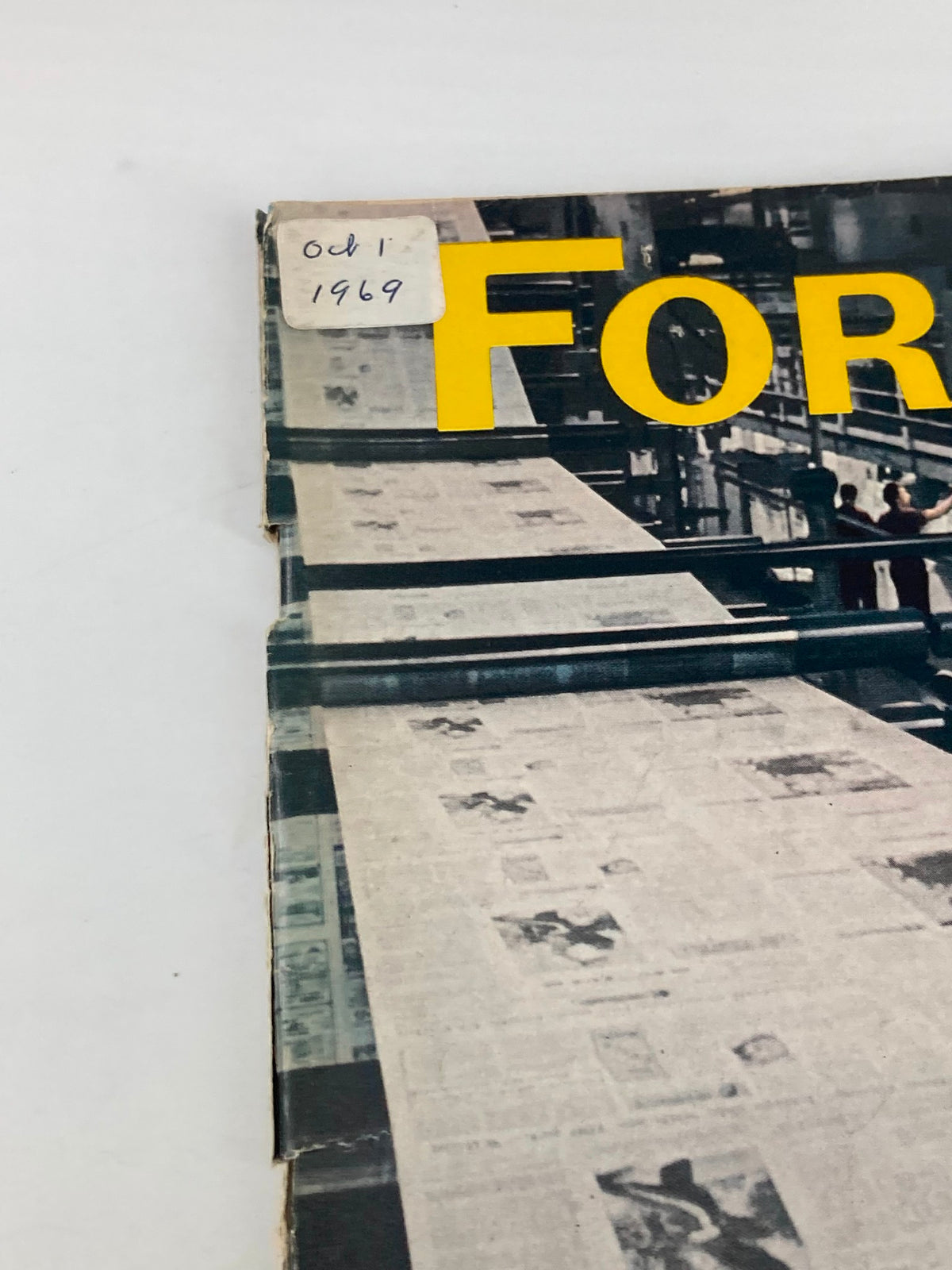 Close-up of the corner of VTG Forbes Magazine October 1 1969, displaying the date and the title 'FORBES' along with a printing machinery backdrop.