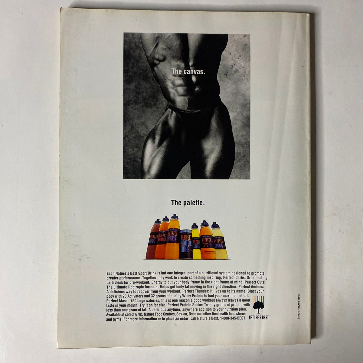 Back cover of IronMan Magazine October 1994 Vol 53 No 10 featuring a black and white muscular model with the text 'The canvas. The palette.' and showcasing various sports drink bottles by Nature's Best. This vintage bodybuilding magazine is in very good condition with minor wear.