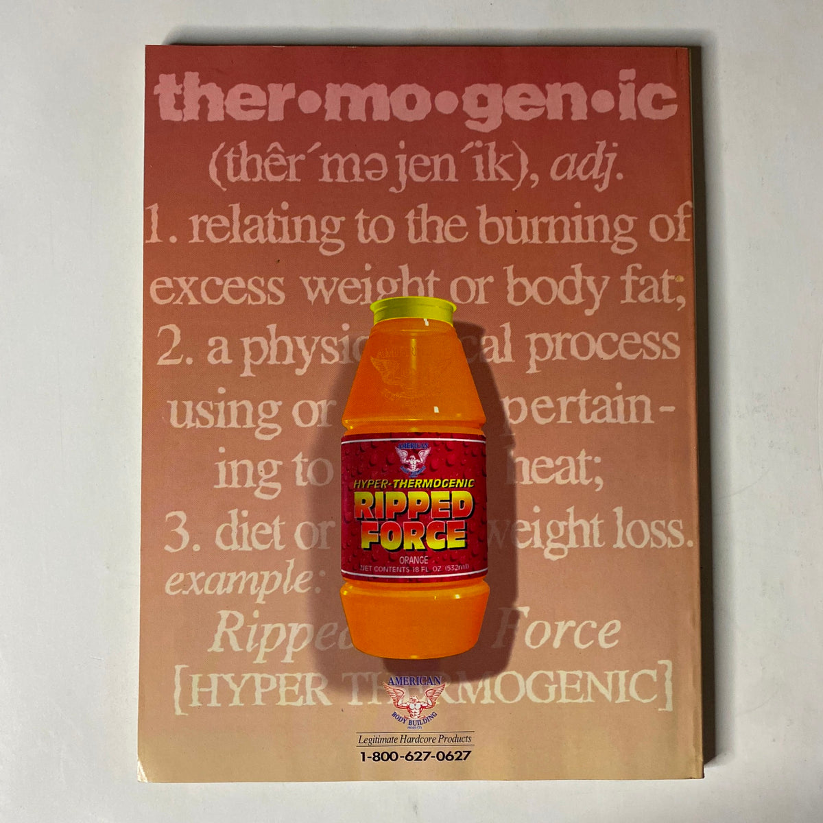 An orange thermogenic supplement bottle labeled 'Ripped Force' positioned on top of a page with a definition of thermogenic, part of the IronMan Magazine May 1995 issue.