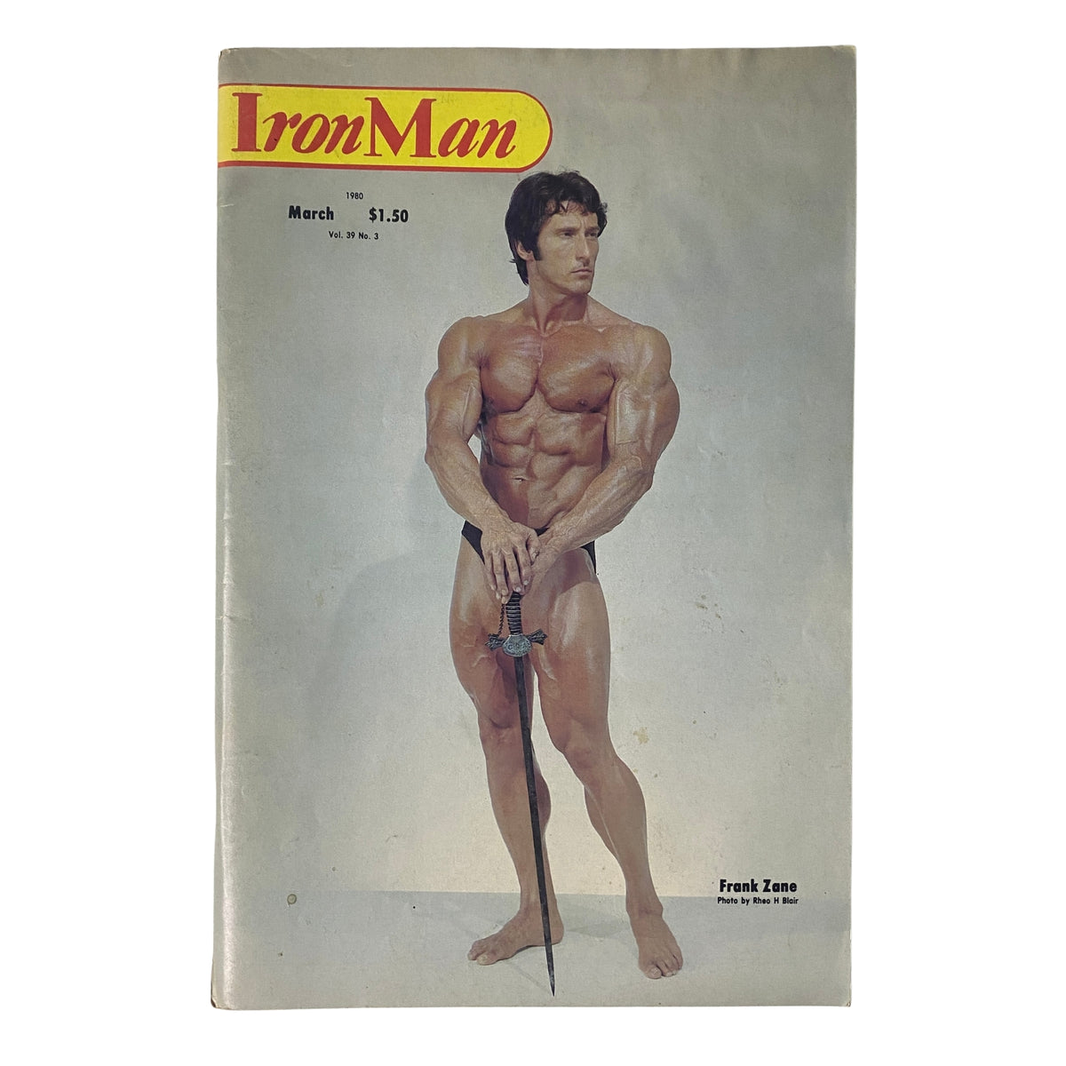 Cover of IronMan Magazine March 1980 Vol 39 No. 3 featuring Frank Zane posing with a sword, showcasing classic bodybuilding aesthetics.