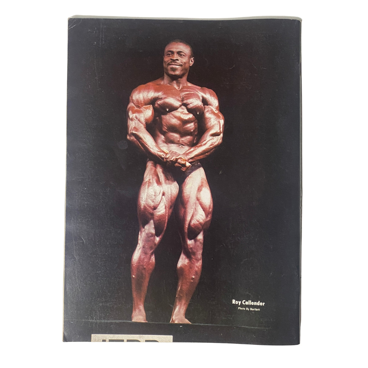 Back cover of IronMan Magazine May 1985 Vol 44 No. 4 featuring bodybuilder Roy Callender, displaying impressive physique and strength.