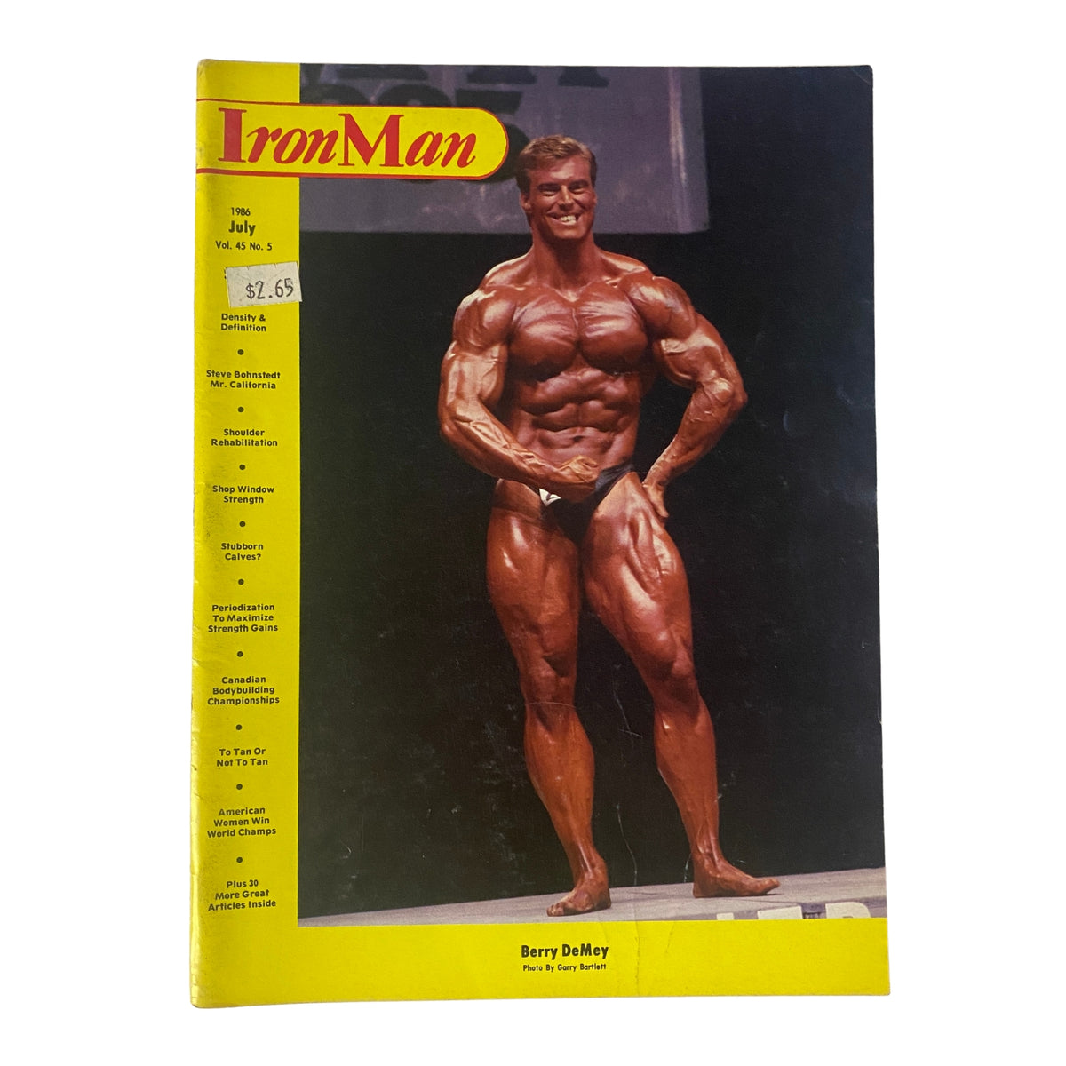Cover of IronMan Magazine July 1986 Vol 45 No. 5 featuring Berry DeMey, a renowned bodybuilder, showcasing his muscular physique.