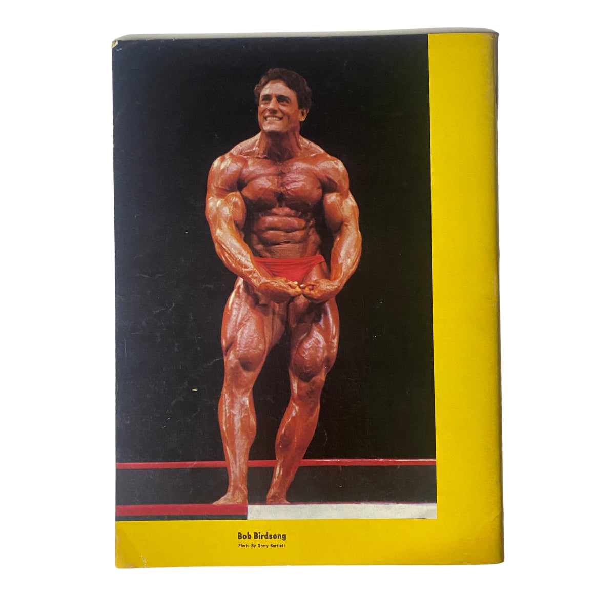 Back cover of IronMan Magazine September 1986 Vol 45 No. 6 showcasing Bob Birdsong in a muscular pose, emphasizing the magazine's vintage bodybuilding theme.